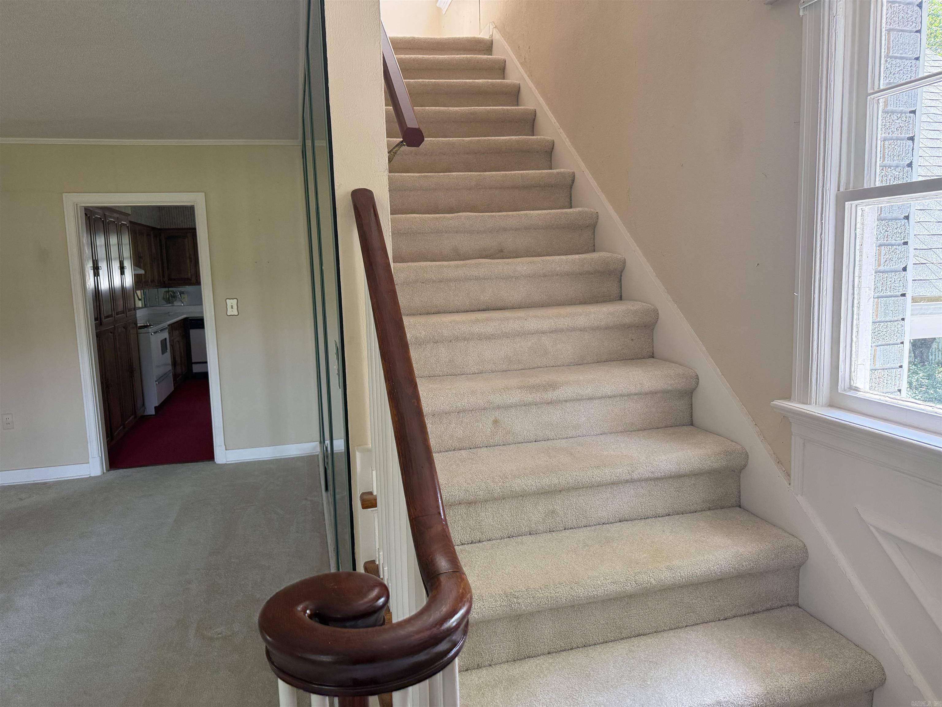 Stairway to two bedrooms and bath upstairs
