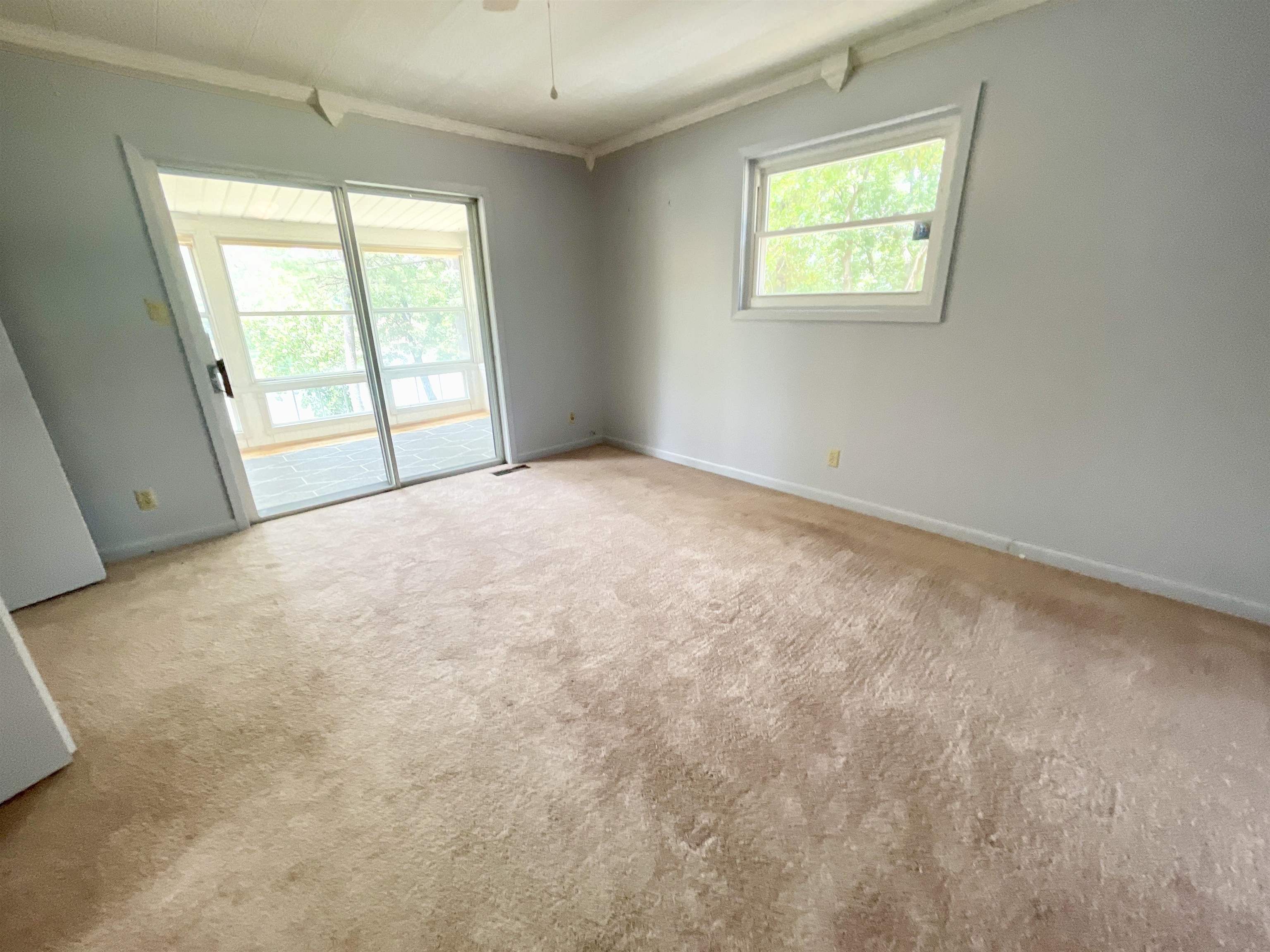 PRIMARY BEDROOM WITH ACCESS TO BACK SUNROOM