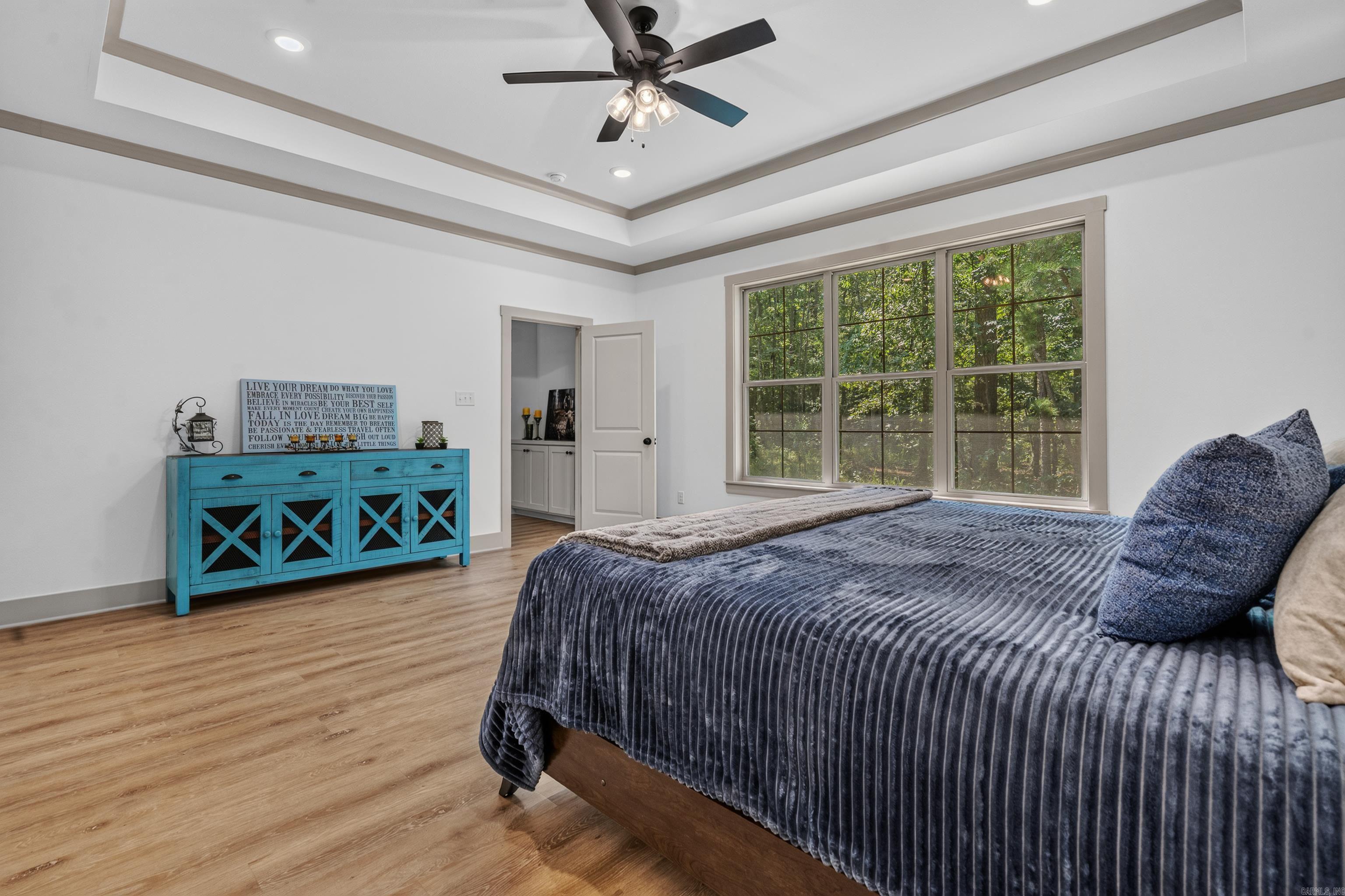 large primary bedroom with scenic views