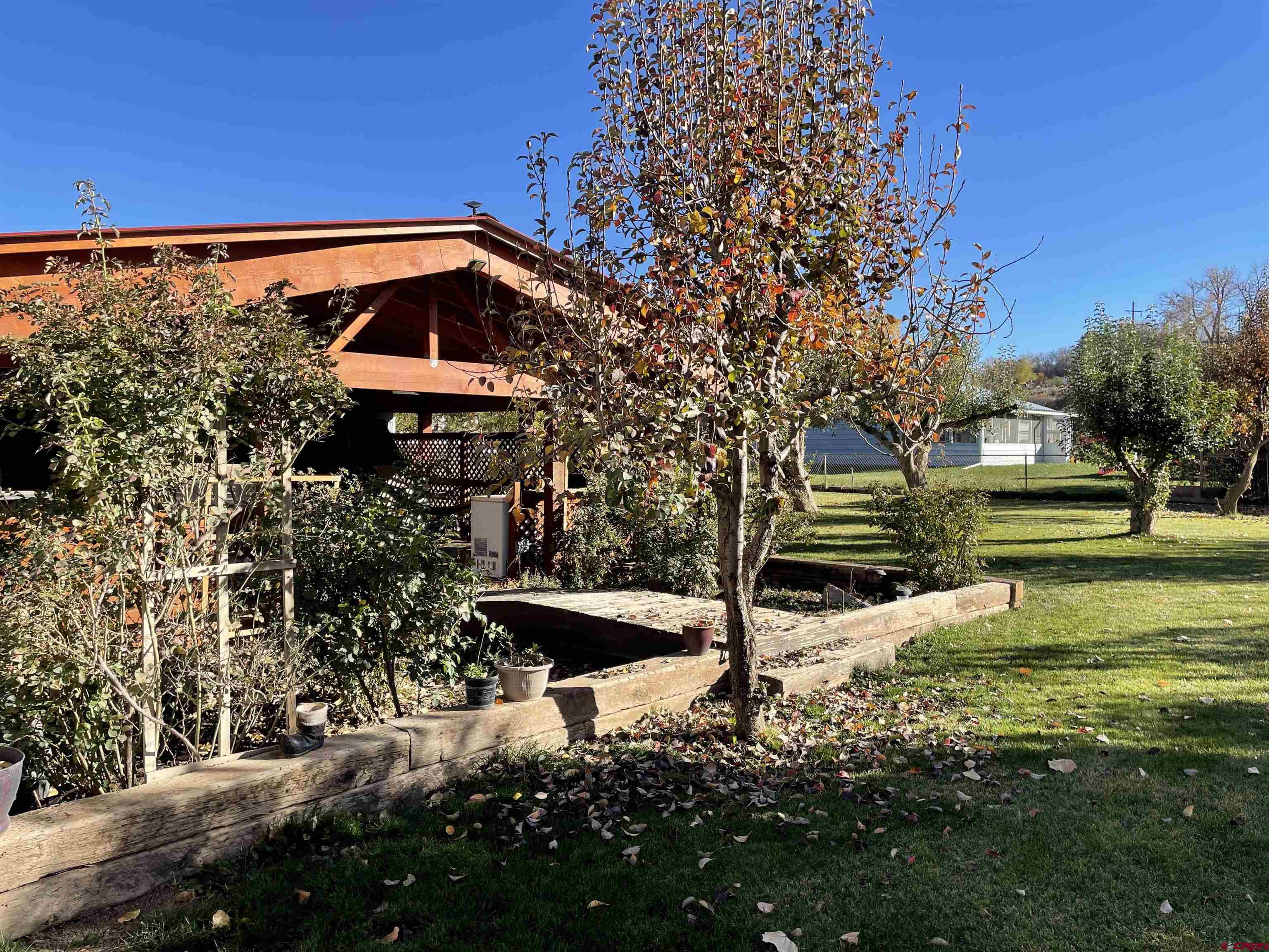 Wait until you see this yard! It features a Pizza oven, storage shed, work shed, large covered deck area perfect of large gatherings. Open shed for lawn mower and yard tool storage, small chicken coop, lots of mature trees, Large parking area and a Tree house for those kids or grandkids.This home sits on almost a full acre (.9 acres)  and features 4 bedrooms,  1 3/4 baths. 1680 sq ft. 2 wood stoves to keep the winter heat bills low.