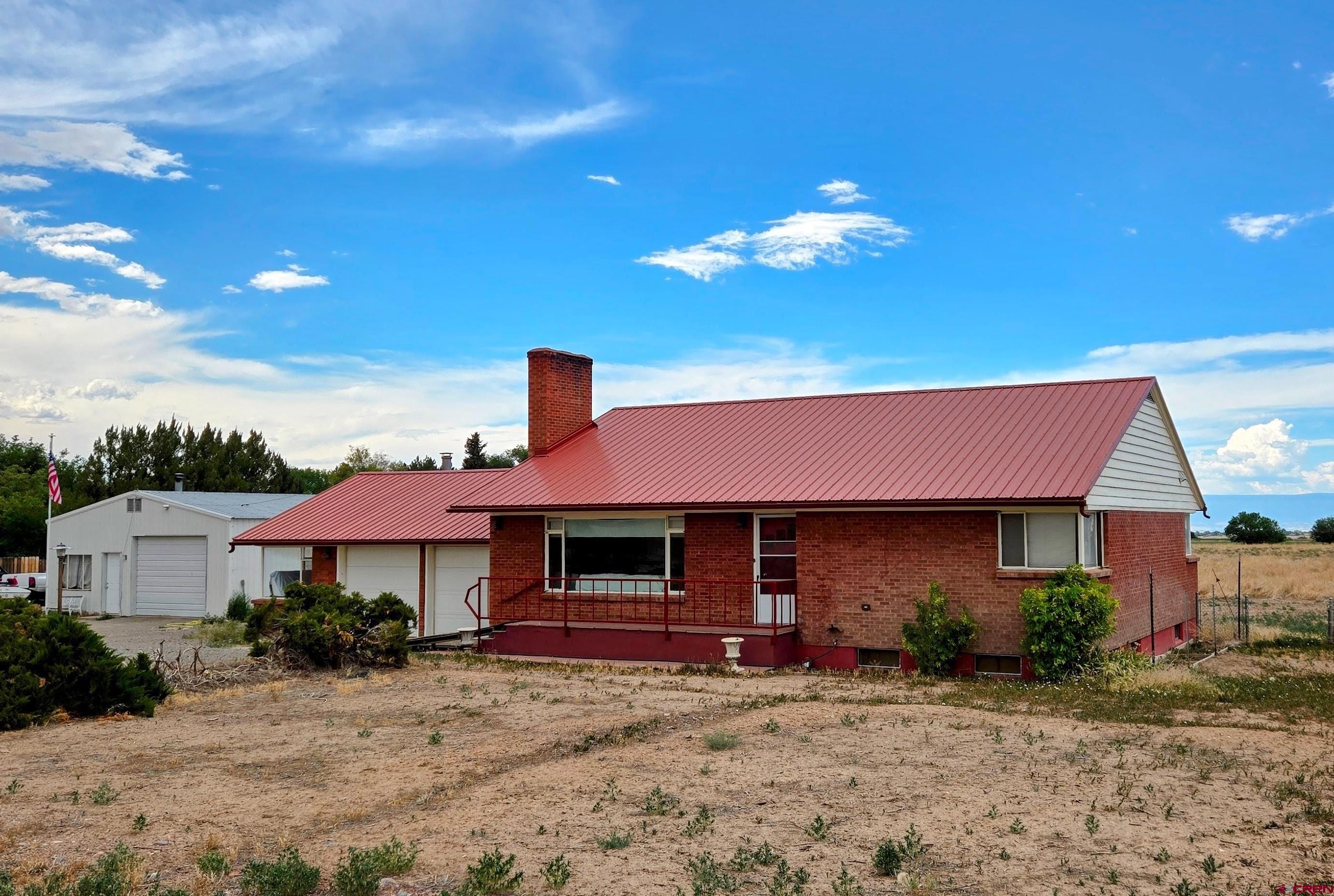 Price Reduced! This is a duplex-styled home, along with a heated workshop, 12.9 acres of irrigated farmland, on beautiful Spring Creek Mesa, with direct views of the San Juan Mountains to the south.  The main level of the home has 2 bedrooms, a full bath, large living room and the kitchen with dining area.  All flooring except the kitchen is original hardwood. Below ground is a similar floorplan which was totally built-out in 2018 and now utilized as fully furnished rental unit.  Additionally, the basement has two stairway entrances; one from garage and the other out back.  Recent upgrades also include a new on-demand hot water boiler system, with side-arm tank, for heating and domestic.  Plus, all new electric service throughout.  The 50 X 30 ft shop has a slab floor, insulation, plus front and rear roll-ups.  The attached garage has room for 3 vehicles, includes a woodstove for heat and has an oil-change pit in the floor.  The back 11 acres has underground irrigation pipes has been successfully farmed up until last year.