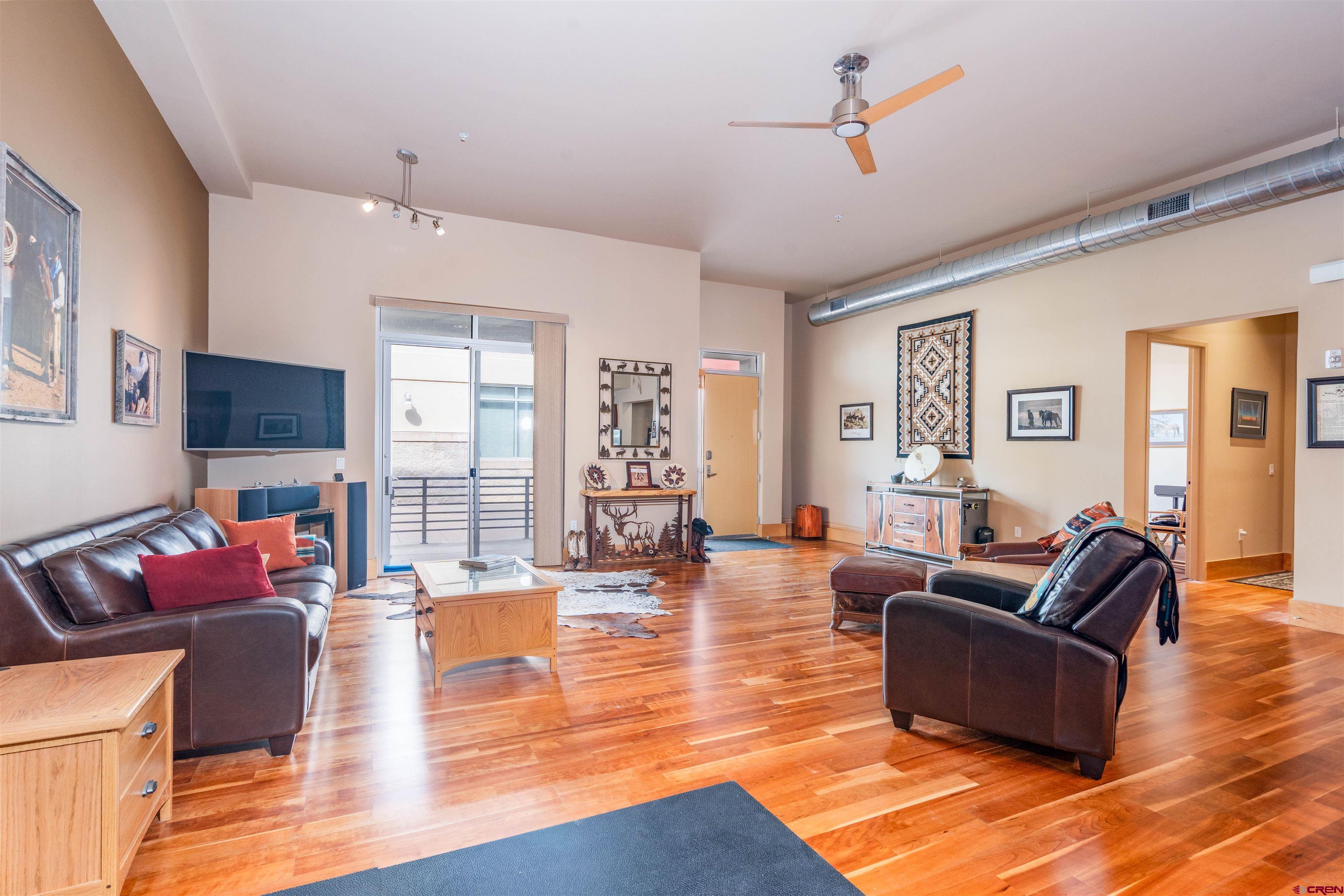 Welcome to effortless living along the Animas River in one of Durango’s most desirable communities, The Rivergate Lofts. This stunning single-level, two-bedroom, two-bath condo offers a rare blend of urban convenience and natural serenity, just steps from the scenic river trail and pedestrian bridge; that leads you right into the heart of South Durango, and runs all the way to downtown Durango. You can truly have a car-free life living here if you desired! Enjoy secure, private parking and your own storage space.  Impeccably maintained and the demo version; everything in this unit is an upgrade. Featuring an open-concept great room with soaring ceilings, cherry hardwood flooring, and large windows that fill the space with natural light. The kitchen is appointed with slab granite countertops, stainless steel appliances, a sit-up bar, and ample cabinet space, including a walk-in pantry. The primary suite is a peaceful retreat with a luxurious ensuite bath, custom walk-in closet, and elegant finishes throughout. The flex bonus space is ideal for a home office, gym, or creative studio tailored to suit your lifestyle. A 100 sq. ft. private patio extends your living space outdoors, while a reserved garage parking space and secure storage unit add convenience and peace of mind. Rivergate Lofts is known for its contemporary architecture, secure building access, elevator service, and unbeatable location. Enjoy walkability to local favorites like Zia Taqueria, Serious Texas BBQ, Natures Oasis, Durango Joe’s, and the Durango BMX track, all while being tucked away in a quiet riverside setting. This area is also expanding with the Durango Mesa park, and just steps away from Animas Surgical Hospital. Offered mostly furnished with tasteful, Western-inspired décor, this is a turnkey opportunity to enjoy low-maintenance living—perfect as a full-time residence or a lock-and-leave getaway. Don’t miss your chance to own in this vibrant and sought-after riverfront community.