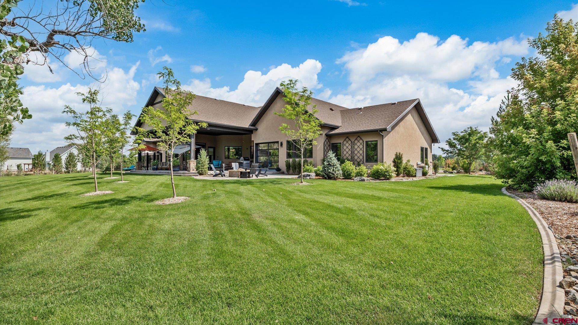 Montrose, CO Custom Luxury Home on 3 Acres with Creek Frontage   Welcome to one of the finest luxury homes on the Montrose market, offering nearly 7,000 square feet of spacious living in a timeless modern design. Situated on 3 beautifully landscaped acres, this 5-bedroom, 5.5-bath custom home was built in 2016 and is thoughtfully designed for multi-generational living, entertaining, and enjoying Colorado’s natural beauty. Spring Creek meanders through the back yard, offering a peaceful setting and a natural water feature right outside your door. The owners of this home have added significant improvements to the property, fully paved driveway, new paint throughout, pristine landscaping, and outdoor living areas.   Located in the desirable Spring Creek neighborhood, just 3.7 miles from downtown Montrose, the property offers easy access to shopping, dining, and services—yet retains a quiet country setting surrounded by farms, ranches, and estate homes. It’s rare to find a home that blends elegant comfort, smart functionality, and high-end finishes with such a premium location.  Highlights:  6,796 total finished sq ft  5 bedrooms, 5.5 bathrooms  5 garage bays (some oversized)  Two large offices (one could be 6th bedroom)  Game room with wet bar  Full gym with roll-up door to back yard  2 laundry sets, laundry chute, pass-through  Mother-in-law suite w/ attached garage  3 irrigated acres with 90+ trees and pressurized irrigation system  Spring Creek frontage  $400/year HOA, includes landscaping water  Paved driveway, extensive landscaping (17-zone system)  Knotty hickory floors; knotty alder trim and cabinetry  Oversized granite countertops, butler’s pantry, high-end Kohler fixtures  Custom metal railings and dry-stacked stone fireplace  Covered outdoor living spaces along the creek  The main level includes an open-concept great room with a spacious kitchen and center island overlooking the living area, plus a butler’s pantry and a smaller study or media room. The primary suite features a luxurious 5-piece bath with steam shower and a large walk-in closet. On the opposite end of the house, a private guest or in-law suite includes its own living area, bedroom, and bath. Upstairs, three bedrooms each have an en suite bath, plus there's a powder room downstairs.  Additional features include a large mud room with built-in lockers, a custom-crafted staircase with iron railings, oversized garage bays for trucks or a workshop, and an engineered septic system. The home is serviced by Chipeta Water District and natural gas.  Lifestyle & Location: Montrose is a growing Western Colorado hub with a newly expanded regional airport offering flights to major cities. World-class outdoor recreation surrounds you: Black Canyon National Park, Gunnison & Uncompahgre National Forests, Telluride, Ouray, and more. Local amenities include a 75-bed hospital, a 80,000 sq ft rec center, performing arts venues, shopping, restaurants, and schools. Whether you're seeking a legacy home, multigenerational residence, or executive retreat, this Montrose custom property delivers it all. Inspection report completed and in-hand.