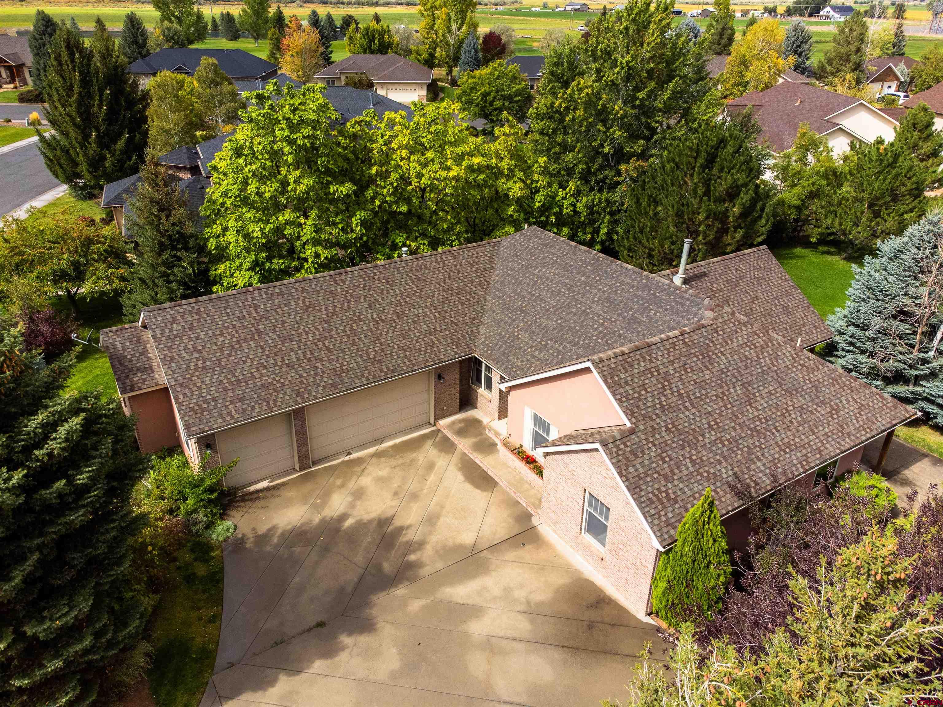 The seller is offering a generous buyer concession of $10,000.00, giving you valuable flexibility to buy down your interest rate, cover closing costs, or make personalized improvements.  Welcome to 3924 Mt Hayden Dr, a beautiful 3-bedroom, 2-bath home with 2,206 sq ft of open-concept living on a meticulously landscaped .36-acre lot. The generously sized primary bedroom features a walk-in closet plus additional closet space and a luxurious ensuite bathroom, providing a private retreat. On the opposite side of the home, two additional bedrooms share a full bathroom, offering privacy and comfort for family or guests.  The home also includes an inviting entryway and a bonus room that could easily serve as a fourth bedroom or home office, adapting to your lifestyle needs. Enjoy cozy evenings by the double-sided gas fireplace connecting the living area to the exquisite formal dining room, perfect for entertaining. Step outside to the covered back patio, surrounded by mature trees and a fenced yard, offering a serene and private outdoor space.  Included with the home is a prestigious Cobble Creek Club membership, just a short walk to the clubhouse, featuring a full-service bar and restaurant, spa, yoga studio, gym, pro shop, and golf simulator. Miles of scenic bike trails and single-track paths connect directly to the neighborhood, allowing you to embrace an active lifestyle with breathtaking vistas—without the crowds or hassle.  Experience Montrose’s unmatched weather and seasonal beauty, year-round golf opportunities, and a lifestyle that combines luxury, recreation, and tranquility. This home is more than a residence—it’s your gateway to the ultimate Colorado lifestyle. New Carpet being installed soon! The Club membership costs about $171.67/month in addition to the HOA fees. Some photos of this listing may include virtually staged amenities, furniture or fixtures.