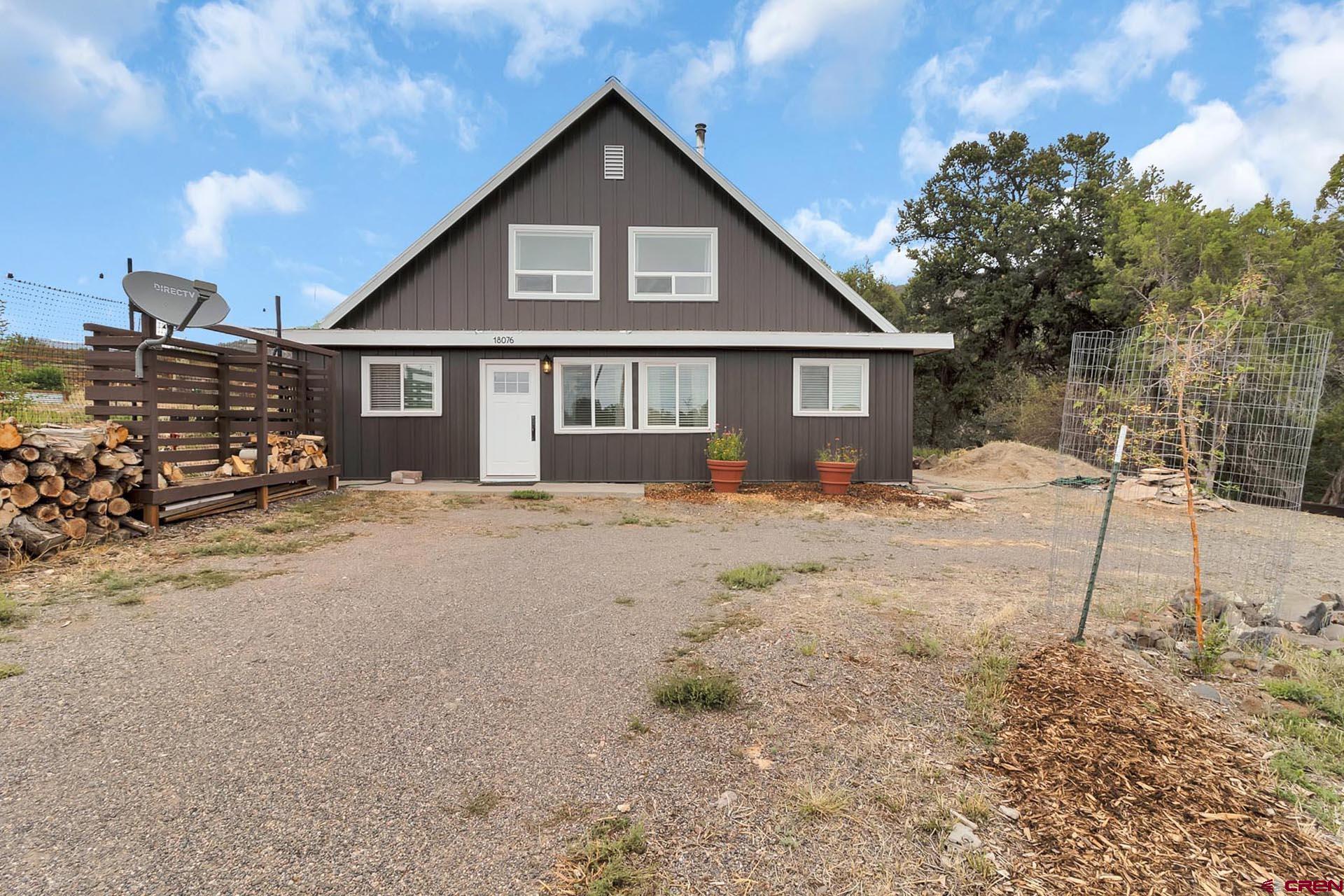 Updated home on over an acre located on a quiet road just minutes from Cedaredge. Nice wooded location with good privacy, views, and no HOA or covenants. Set up to garden with great spaces and deer fencing. Newly remodeled interior including the kitchen and bathrooms give you clean and fresh update throughout and in the most important rooms. Good natural light and open spaces give it a bright and fresh feeling. New wood stove for primary heating with electric baseboard to back it up. Private covered back porch is the perfect spot to relax and read out of the summer heat. Low maintenance  exterior with metal roofing, new metal board and batt style siding, and real rock wainscoting. Room to build a shop or garage. Overall very clean and well updated home with some acreage, privacy, and views.