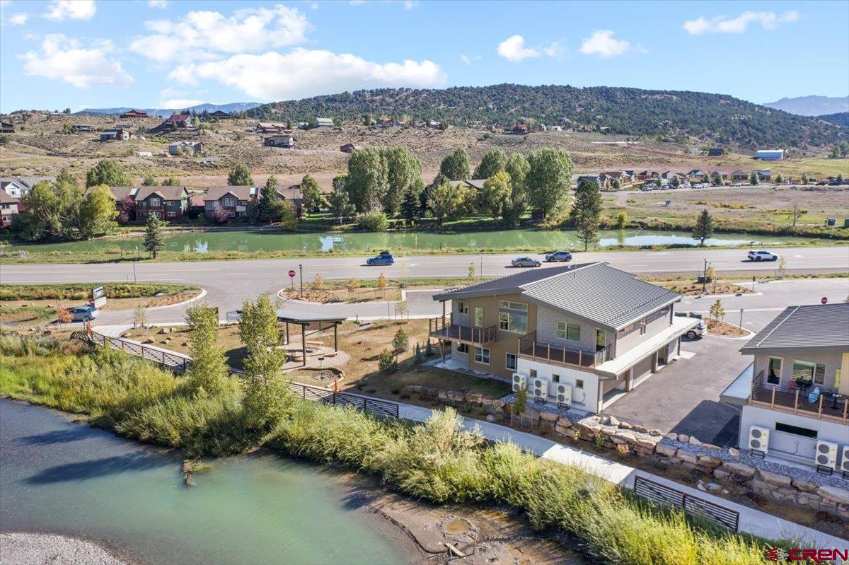 Discover modern mountain living in this stunning one-bedroom, one-bath condo located on the banks of the Uncompahgre River. Featuring state-of-the-art construction and contemporary design, this residence offers an abundance of natural light through expansive, high-end windows that frame spectacular views of the Sneffels Range and Cimarron Ridge. The thoughtfully designed floor plan includes an attached one-car garage, perfect for storing all your mountain gear and toys. Inside, sleek finishes and modern craftsmanship create a warm, inviting atmosphere for both full-time living and a lock-and-leave retreat. Just steps away, the hiking and biking path connects directly to Ridgway’s vibrant downtown, where you’ll find local dining, shops, and community charm. With its rare riverfront setting, walkability, and private garage, this condo is truly a one-of-a-kind residence in Southwest Colorado. Don’t miss the opportunity to own a brand-new home in one of the most desirable locations in the San Juan Mountains. Some photos of this listing may include virtually staged amenities, furniture or fixtures.