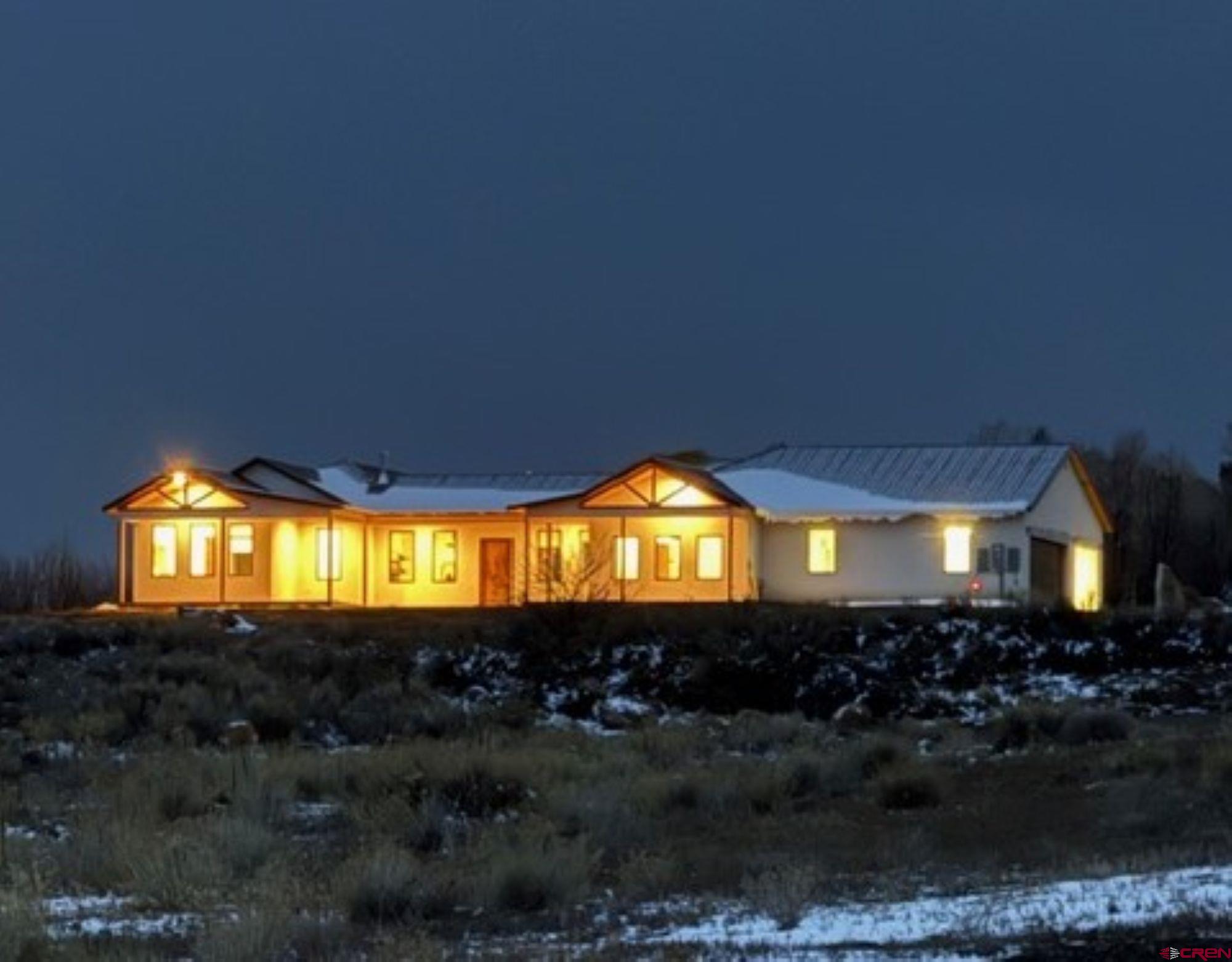 This 2800+ sq ft newly built custom home sits on a stunning 3 +irrigated  acre lot overlooking beautiful Spring Creek Mesa. The residence features four bedrooms and three bathrooms, with an oversized 3 car-attached garage. Spacious kitchen with Quartzite countertops, ample counter space, and two ovens for convenient cooking.  The large 7’ x 15’ walk-in pantry is spacious with plenty of room for storage of small appliances and extras. There is a separate dining area that has built in custom cabinets and Alder doors leading to the large deck for entertaining guests. The large & spacious living room include natural hickory flooring and 10 ft ceilings throughout the entire home. There is built in shelving and a beautiful stone surrounding wood burning stove. The large windows in the living room add natural light and highlight the views of beautiful Spring Creek Mesa. The primary bedroom is large and continues with the natural hickory flooring. The bathroom features a stand-alone tub, large walk-in tiled shower, and his & hers Quartzite counters with double sinks. There is also a large walk-in closet. The three additional bedrooms also have hickory flooring and Alder doors. There is a half bath with a sink conveniently located off the garage entrance and large mud room. Outside features include natural wood decking in front and the back of the home. There are large natural wood exposed beams on the front and back porches with tongue and grove soffits. The owner originally built this home for himself, so you know there was a little extra care put in the construction, this is not your typical spec home. This house is well-built from foundation to roof and includes a protective French drain for the foundation.   The insulation is also the best you can get with closed cell spray foam in the walls and roof decks. The paint is eco-nontoxic. The base is secured atop a 16-inch thick sandstone layer, providing reliable support and stability.