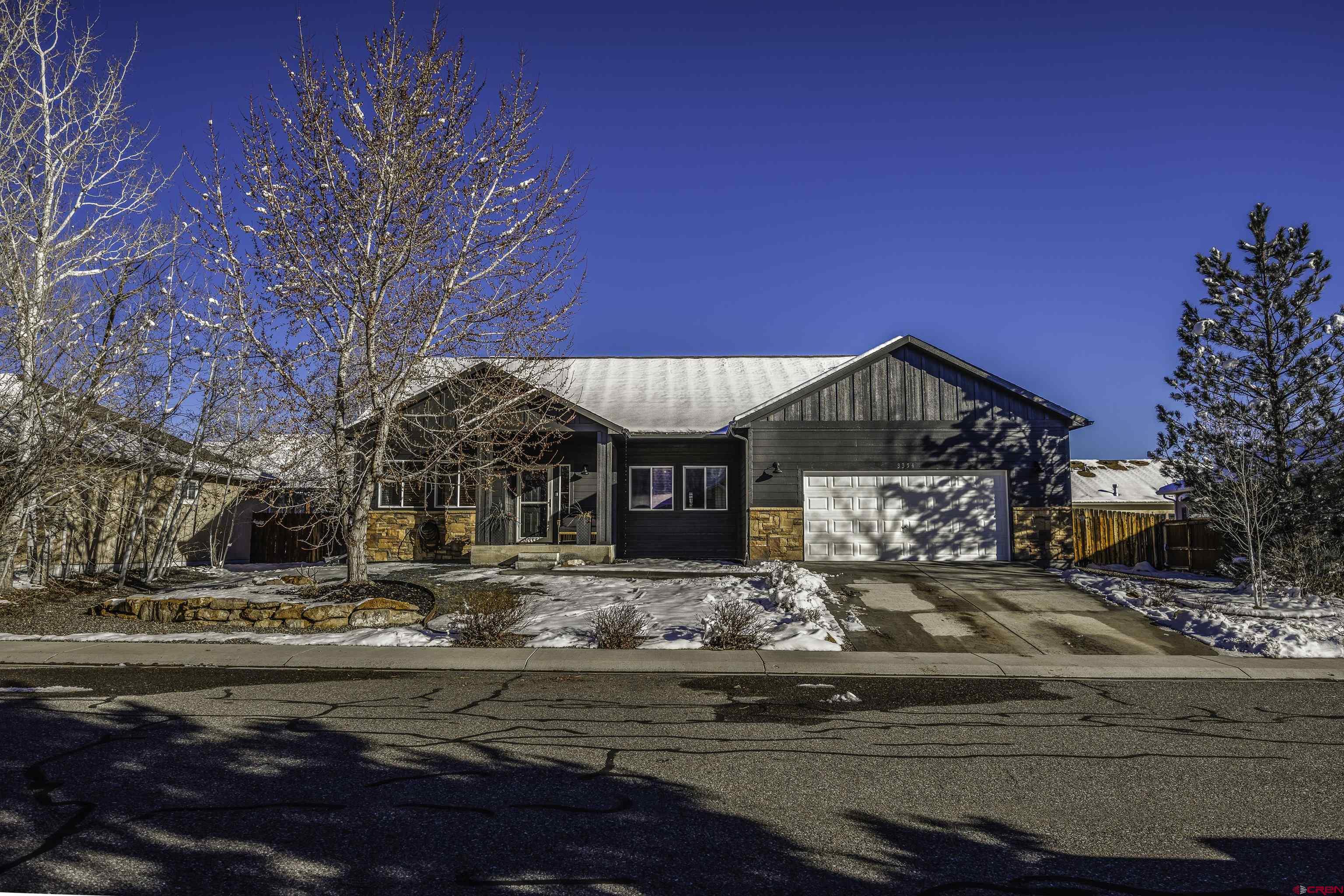 Inviting and warm, this move-in-ready, beautifully updated home in the desirable Raven Crest subdivision is just the place for you! Fresh exterior paint in an attractive modern hue enhances the charming curb appeal and welcoming covered front porch. Inside, a spacious entryway leads you to a versatile den/flex/office/formal dining room to the right, and straight ahead into the open living room featuring a cozy corner fireplace with a mantel. Vaulted ceilings elevate the space, creating an open and airy feel. Flowing into the dining area, you’ll discover stunning built-ins and floating shelves that add designer flair to this already impressive living space. The kitchen boasts newer appliances, herringbone patterned subway tile backsplash, and tastefully painted cabinetry, along with thoughtful conveniences including main and corner cabinet pull-outs and built-in spice storage. This split floor plan places the primary suite on one side of the home, complete with a full ensuite bath offering a private water closet and generous linen storage, as well as convenient access to the laundry room. On the opposite side are two nicely sized bedrooms and a full hallway bath. The fully fenced backyard features a covered patio and well maintained grass, perfect for relaxing or entertaining. Completing the property is an oversized attached two-car garage. Let us bring you home - schedule your showing today!