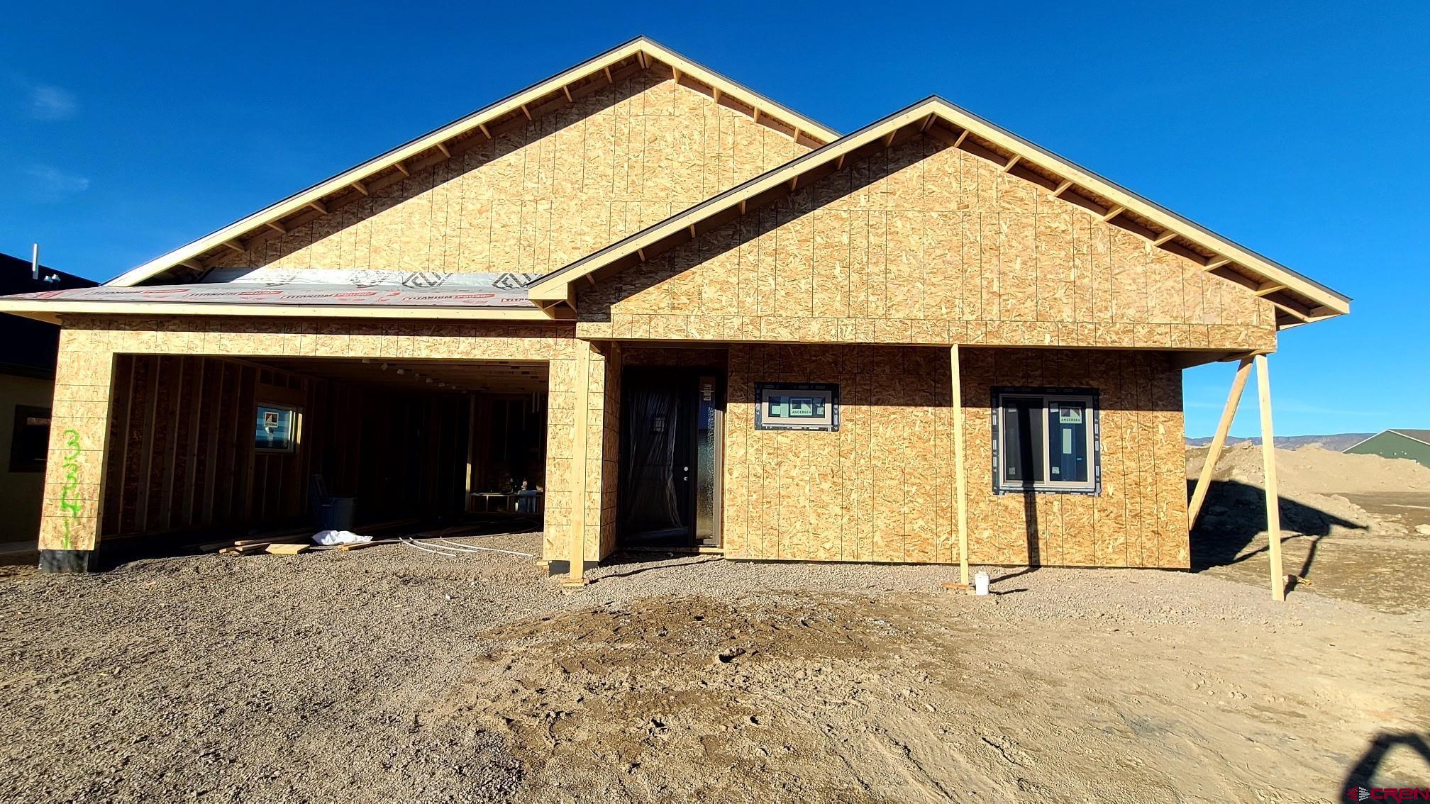 Beautiful New Construction! This thoughtfully designed 4-bedroom, 2.5-bath home offers 2,122 sq ft of quality craftsmanship and modern comfort. Step inside to an inviting open-concept living, dining, and kitchen area, highlighted by a stunning 10-ft kitchen island, 42" custom dovetail upper cabinetry, and soft-close roll-out trays in all lower cabinets—a dream workspace for any home chef.  The spacious living room features a floor-to-ceiling stone gas fireplace, creating the perfect gathering space. The primary suite is a true retreat with in-floor heat in the master bath and beautifully tiled shower and bath areas floor-to-ceiling.  Function meets convenience in the oversized finished garage with an 18-ft door, extra space on both sides, trim and paint completed, and a tankless water heater. The home also includes natural gas forced-air heating, central A/C, and quality finishes throughout.  Enjoy Colorado living outdoors on both the covered front entry and rear patio, accented with attractive blue-stained pine.  Crafted with the attention to detail, this brand-new home offers comfort, style, and durability—Construction to be finished approximately June, 2026.  You still have time for some choices.