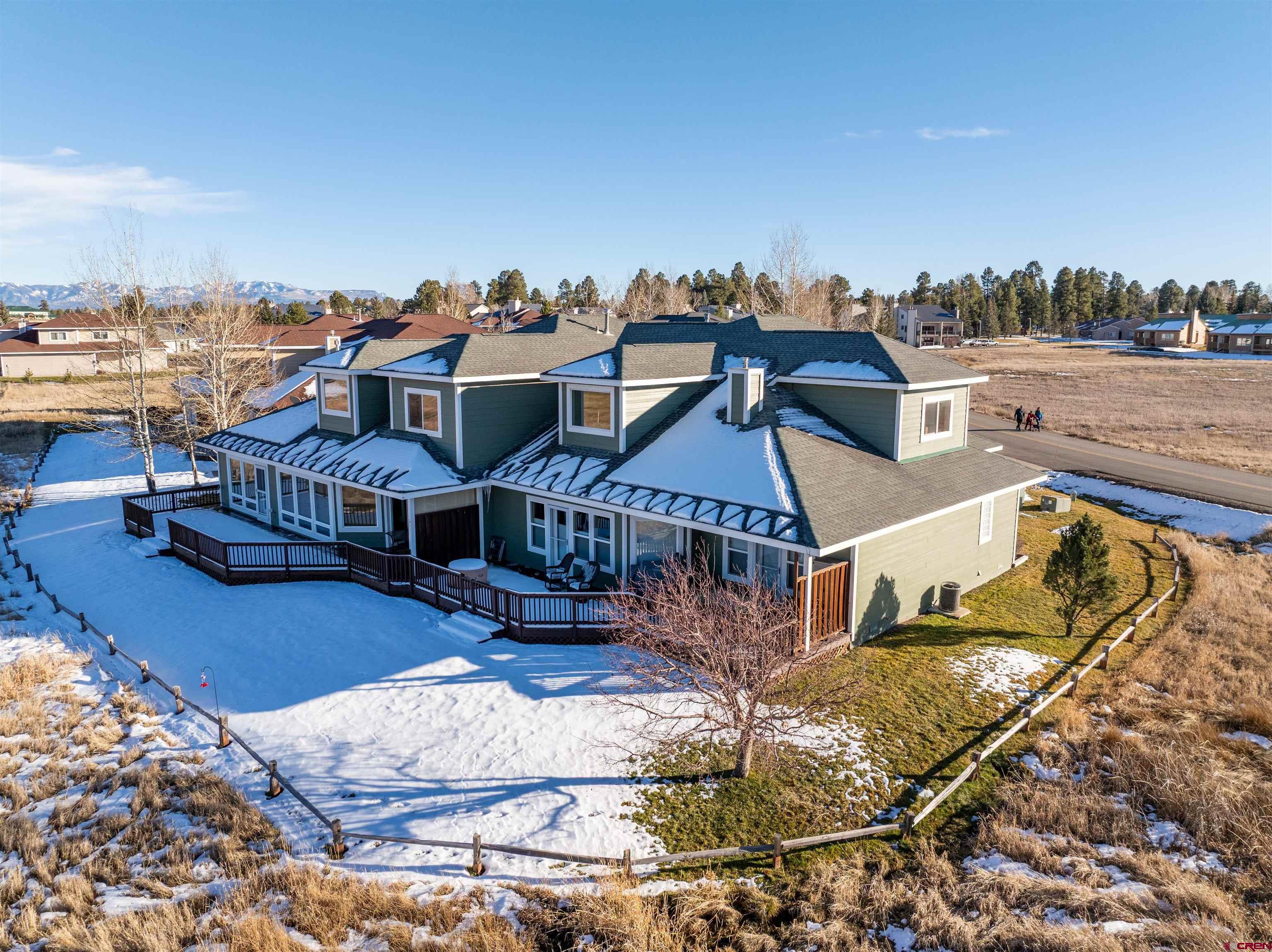 Don’t miss this opportunity to own a beautifully appointed 3-bedroom, 2.5-bath townhome in Pagosa Springs, Colorado, offering breathtaking Pagosa Peak mountain views, golf course scenery, and a true lock-and-leave lifestyle. Ideally positioned adjacent to a greenbelt with unobstructed views of the golf course, this immaculate townhome combines privacy, scenery, and convenience in one of Pagosa Springs’ most desirable communities. The primary suite is located on the main level, featuring a walk-in closet, double-sink vanity, jetted bathtub, separate shower, and private access to an oversized deck, perfect for taking in mountain sunsets and year-round views. Upstairs, two additional bedrooms each offer walk-in closets, along with a versatile loft space ideal for a den, office, or TV room. The open-concept floor plan is designed for both everyday living and entertaining, with a spacious kitchen that flows seamlessly into the living and dining areas, all framed by expansive windows and mountain views. Recent upgrades make this home truly stand out, including gorgeous beetle-kill wood ceiling accents, laminated wood flooring, and newer high/low honeycomb blinds on all windows, with heat-blocking blinds upstairs for summer comfort. Natural gas heat and a gas fireplace keep utilities efficient, while central heating and cooling ensure year-round comfort. A climate-controlled garage adds valuable storage and functionality. Outdoor living is a highlight, with multiple oversized decks, including a covered deck off the primary suite and an open deck off the living area, all overlooking the greenbelt and golf course while maintaining excellent separation and privacy from play. This townhome is part of a well-managed HOA that covers building insurance, exterior maintenance, roof, lawn care, snow removal, and private road and parking area upkeep, making ownership simple and stress-free. Ownership also includes access to four private PLPOA lakes for fishing and canoeing, as well as the newly expanded Pagosa Lakes Recreation Center. Located just minutes from downtown Pagosa Springs—and within walking distance to shopping, coffee shops, restaurants, and the recreation center—this property offers the perfect balance of mountain living, modern comfort, and everyday convenience. Whether you’re searching for a Pagosa Springs townhome, a mountain retreat, a full-time residence, or investment, this exceptional property delivers views, upgrades, lifestyle, and location in one complete package.