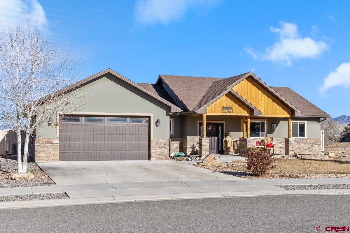 Welcome to 302 Howard Fork Avenue, a beautifully maintained home built in 2018 that blends modern comfort with timeless charm in the heart of Montrose. Offering 1,716 square feet of thoughtfully designed living space, this inviting residence features three spacious bedrooms and two full bathrooms, providing both functionality and comfort for everyday living.  The open-concept layout is filled with natural light and flows seamlessly from the living area into the kitchen and dining space—perfect for entertaining or relaxing at home. Stainless appliances and plenty of cupboard space with a pantry.  A private primary suite offers a peaceful retreat with a well-appointed ensuite bath with in-floor heat, and new carpet just installed. The two additional bedrooms provide flexibility for guests, a home office, or hobbies. The attached two-car garage adds convenience and ample storage.  Nicely landscaped front and back yard with a vinyl privacy fence.  The raised beds will stay with the property along with the Storage building.  Back Patio and front porch, both great places to have your morning coffee or unwind in the afternoon.  This Seller had the home built by Uncompahgre Valley Builders so it's a one owner home that has been well maintained.