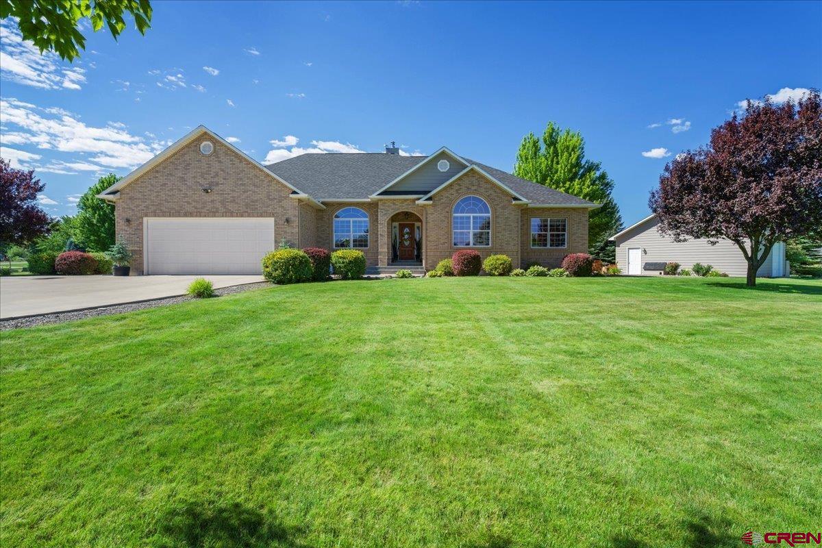 Welcome to this spacious 4-bedroom, 2.75-bath home with 2,084 sq.ft. of living space on the main level and 1,984 sq.ft. finished basement. The home sits on 1.13-acre corner lot that is beautifully landscaped and is in close proximity to the exclusive approx. 10+ acres of HOA river access. The home is accompanied by a 26' x 26' detached shop with a wood stove for year-round use. The main 3 car garage has one side that is 50' long and 25' on the other allowing for additional vehicles or storage. The main level offers 2,084 sq.ft. with large windows that bring in natural light and views to your backyard. The living room has a wood-burning stove and French doors leading to a patio with beautiful views of Buckhorn, hot tub area and fountain on the porch. They remodeled kitchen features oak cabinets, quartz countertops, new stainless-steel appliances, a coffee bar, and a double oven. The dining area is a great place to entertain and to enjoy your morning and evening views. The primary suite has two walk-in closets, an attached bathroom with a jetted tub, separate shower with new glass door, and two sink areas. In the laundry room has access to the garage and you will find a newer washer and dryer as well as sink for easy cleanup! There is new flooring in the upstairs bathrooms and laundry room as well. The basement area (1,984 sq.ft.) is where you’ll find another wood-burning stove, a workout space, a TV/theater room, a 3/4 bathroom, and even room for two single beds—ideal for guests. There is a radon mitigation system in place as well. The home has many different storage areas for your convenience an in addition to the two wood stoves the home has as two furnaces as well. The yard is large and open with many mature trees, a hot tub, firepit area, and an in-ground trampoline. The yard and plenty of space to enjoy outdoor living and the long summer nights. This property is located South of Montrose and is a great location to get to outdoor recreation such as skiing, hiking and camping. Don't miss out on this property and motivated Seller!