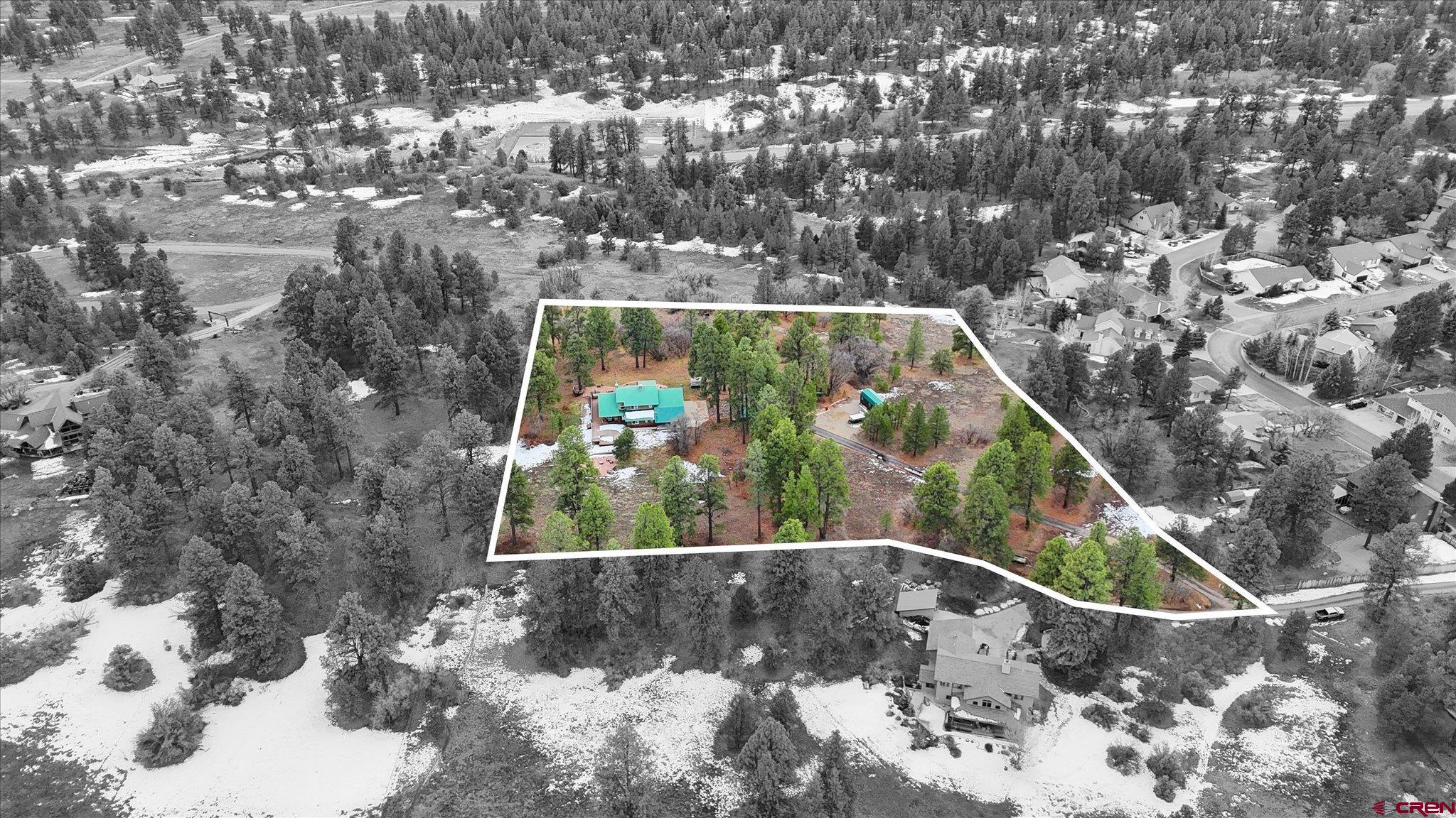 Tucked among towering Ponderosa pines on nearly six private acres, this Durango West II retreat offers the perfect blend of mountain living, space, convenience and only minutes from downtown Durango. Set on a large, usable lot with exceptional privacy and mountain views, the property delivers the serenity of a mountain escape while enjoying paved roads, central water and sewer. Inside, the home features an open, flowing floor plan designed for both everyday comfort and entertaining. The beautifully remodeled kitchen showcases modern finishes, generous counter space, double ovens, and a seamless connection to the dining and great room with an open and airy  layout. Natural light fills the living spaces, highlighted by a dramatic floor-to-ceiling fireplace, vaulted ceiling and a unique atrium area ideal for an indoor garden or peaceful reading nook. The main-level primary suite offers ease and privacy, complete with a spacious walk-in closet and a five-piece bath with a jetted soaking tub. An additional office or flex room on the main level provides space for working from home, hobbies, or guests. Upstairs, two bedrooms, a full bath, and a large bonus flex space with wet bar and deck access create endless possibilities for a media room, game room, or creative studio. Outdoor living is a standout feature, with a wrap-around porch and multiple decks that invite you to enjoy the surrounding forest, wildlife, and mountain air. Excellent storage options, including an oversized three-car garage, workshop/shed, wood storage, greenhouse, RV parking and electric fence around property for dogs. Located in the highly sought-after Durango West II community, residents enjoy maintained hiking and biking trails, parks, tennis and basketball courts, playgrounds, and open space, ideal for those seeking an active Colorado lifestyle. Just 10–15 minutes to downtown Durango, this home delivers the rare combination of privacy, acreage, neighborhood amenities, and easy access to town. A true mountain retreat with room to live, work, and play as this is Durango living at its best. Too many features to list so please call or text for a private showing.