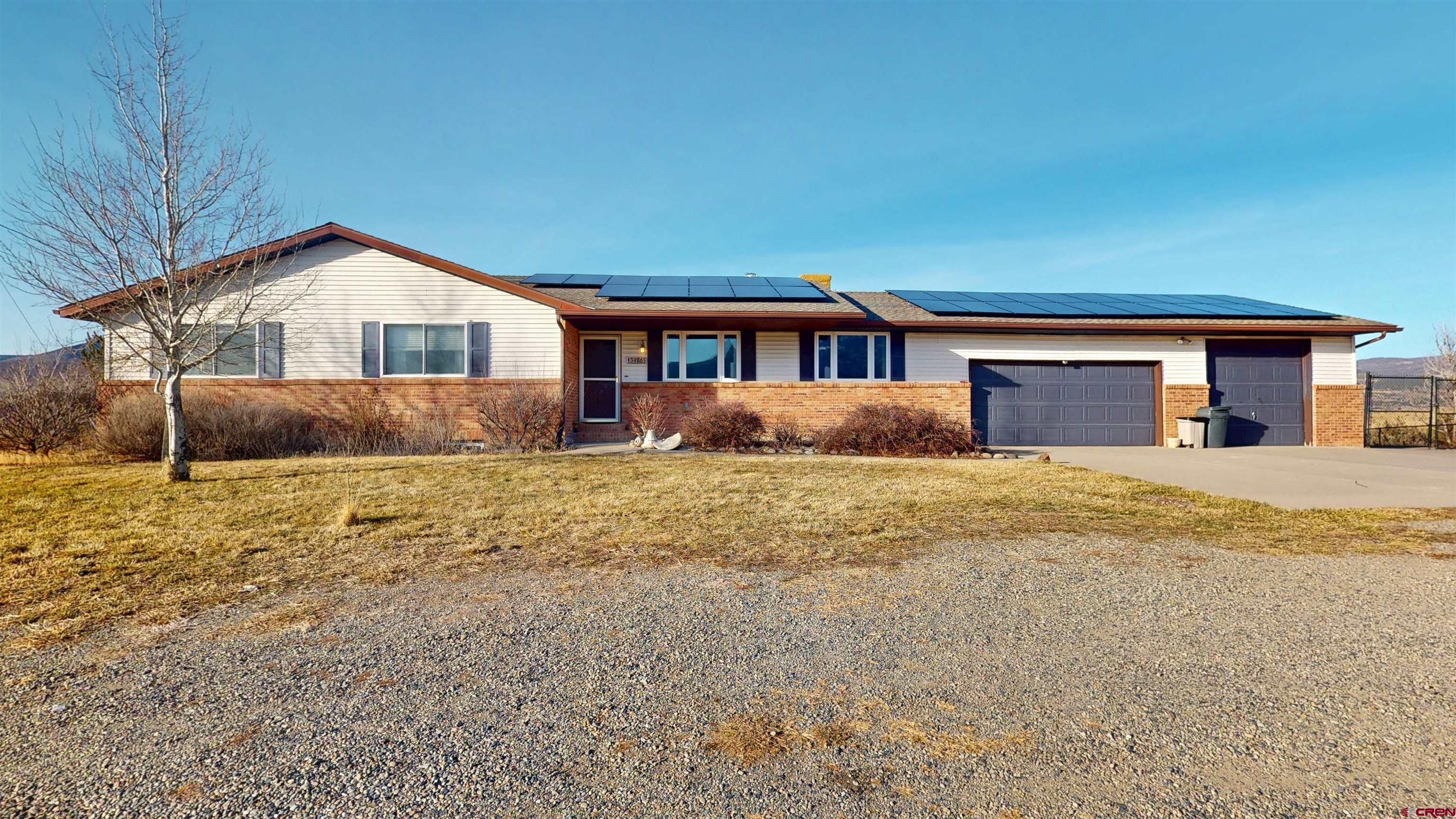 SOLAR, SOLAR, SOLAR Embrace energy independence with an incredible SOLAR power system (approximately 3 years old), designed for efficiency and cost savings keep your power bill to a low minimum with electric company, reducing your footprint and SAVING every month while enjoying the sunny Western Colorado climate.  Nestled in the heart of Colorado's picturesque North Fork Valley, this exceptional 4-bedroom, 3-bathroom home offers the perfect blend of modern comfort, seclusive living on an end of the road 35 acre lot, and breathtaking natural beauty—just minutes from the charming town of Paonia Co. Wake up every day to incredible panoramic views of iconic Mount Lamborn, the majestic centerpiece of the North Fork Valley Mountains, framing your windows like a living masterpiece. This spacious residence features an attached 3-car garage for ample storage and convenience, plus a detached high-quality metal shop/garage—ideal for hobbies, workshops, vehicles, or equipment. The nicely fenced backyard provides privacy and security, while valuable irrigation water rights keep your lush yard, mature trees, and potential gardens thriving in this fertile valley known for its organic farms and orchards. The versatile walk-out basement offers exciting possibilities as a separate living area, complete with its own bedroom, full bath, and kitchenette—perfect for guests, multi-generational living, rental income, or a private retreat. Whether you're seeking a peaceful family home, a sustainable homestead, or a base for exploring the nearby trails, wineries, and outdoor adventures of the North Fork Valley, this property delivers on every level. Don't miss this rare opportunity to own a slice of Colorado paradise!