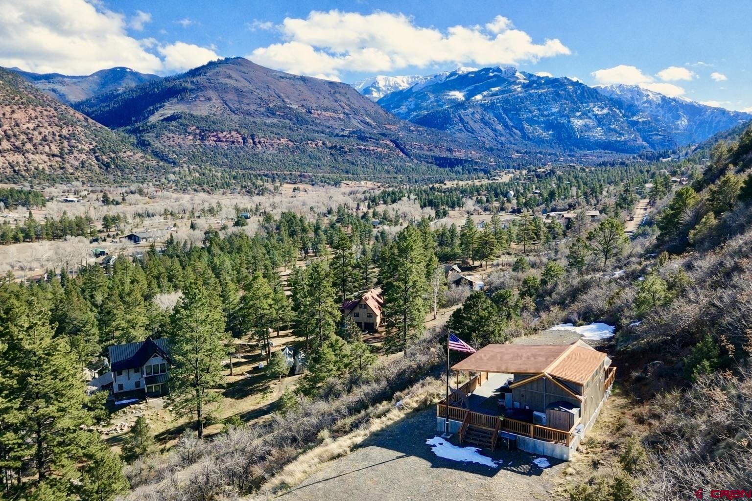 Located in the San Juan Mountains in the Ouray Valley, this 37.5-acre property delivers space, privacy, and year-round access in one of Colorado’s most scenic settings. Just minutes from Ridgway, the gateway to the San Juan Mountains, and Ouray, known as the Switzerland of America, this is a location that truly stands apart. The 480 sq ft home offers a practical and comfortable footprint with sweeping mountain views and a wrap-around deck complete with a hot tub, perfect for taking in the scenery or entertaining during the peaceful summer days. A fire pit creates a natural gathering spot for evenings under the stars. Well suited for people seeking a refined mountain retreat, this property balances outdoor adventure with quiet enjoyment. With utilities already in place, infrastructure to build a larger home, no HOA or covenants, and turn-key readiness, this is a rare opportunity to step into a private mountain setting and start enjoying it immediately.