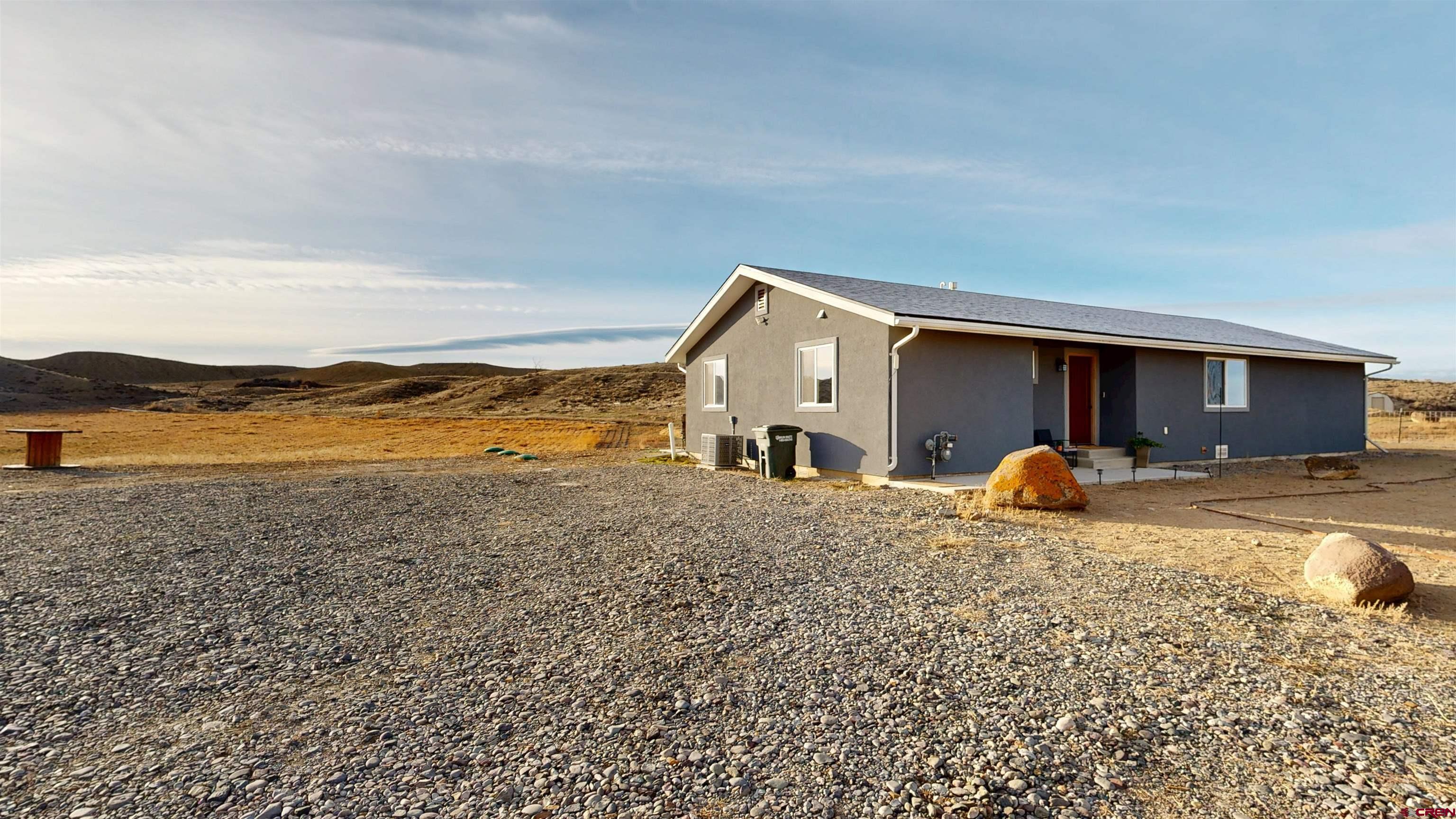 Welcome to wide-open Western Colorado living at 66462 Landfill Rd in Montrose, CO, just 2 miles from downtown with no HOA. Set at the foot of the Black Canyon on 10 beautiful acres with 2.5 shares of irrigation water, this peaceful property offers incredible scenery, usable land, and the space to create your ideal Colorado lifestyle. With few neighbors and breathtaking mountain backdrops, every sunrise and sunset feels like a postcard.  Set in a peaceful location with few neighbors, this property offers the perfect blend of comfort and space. Step outside and take in breathtaking views, with endless skies and mountain backdrops that make every sunrise and sunset feel like a postcard.   Inside, the home is warm and inviting with tasteful updates including granite countertops, a tiled shower, a primary suite, and a water filtration system. The layout works beautifully for full-time living, or a rural retreat. Outside, the acreage offers room for animals, gardening and hobby farming, with the added value of irrigation water to support your land and vision.  Suitable as a horse property, hobby farm, or irrigated acreage just minutes from town.