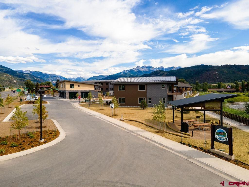 Newly completed Fall of '25.  Perfectly situated as the only Ridgway residential project on the Uncompahgre River, Riverfront Village offers quick highway access to Telluride, Ouray, Silverton, and Montrose while a stroll down the river trail leads to downtown shops and restaurants.   This unit has Box Canyon views into Ouray, a two-plus car garage, Air Conditioning, south south-facing deck, only one shared wall, and is located on the second floor. All tours must be with a RRV Team member.  Some photos of this listing may include virtually staged amenities, furniture or fixtures. Some actual photos are of our model unit representing the finishes planned.  There are other units available that are not currently listed in the MLS, please inquire about additional opportunities.