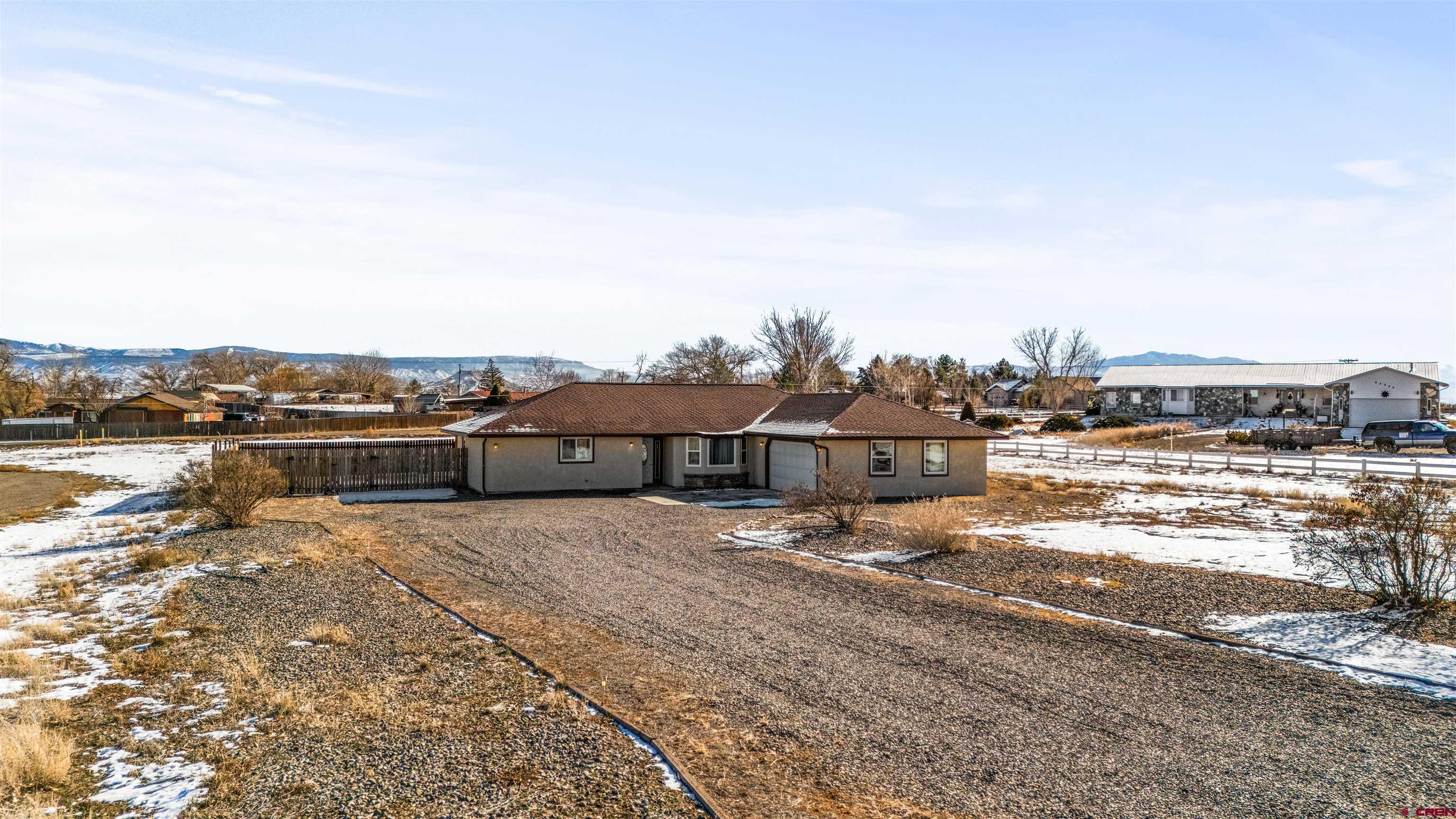 Welcome to 62920 Jeremy Rd—a place where space, comfort, and Western Colorado’s wide-open beauty come together. This well-cared-for 3-bedroom, 2-bath home sits on 1.42 acres, offering privacy without feeling isolated, plus extra living space that adds flexibility for everyday living, guests, or a home office.  Inside, natural light fills the home, enhanced by new windows that improve comfort and efficiency throughout. The fully remodeled kitchen is both functional and inviting, designed for real life—whether you’re cooking for a crowd or enjoying a quiet morning at home. The layout flows effortlessly to the backyard patio, perfect for relaxed evenings or entertaining while taking in views of the Adobes, the Black Canyon, and the Grand Mesa.  The fully fenced backyard creates a peaceful outdoor retreat with room for pets, play, and unwinding. Located in a friendly, walkable neighborhood, this home offers space to breathe, beautiful scenery, and the kind of comfort that simply feels right.