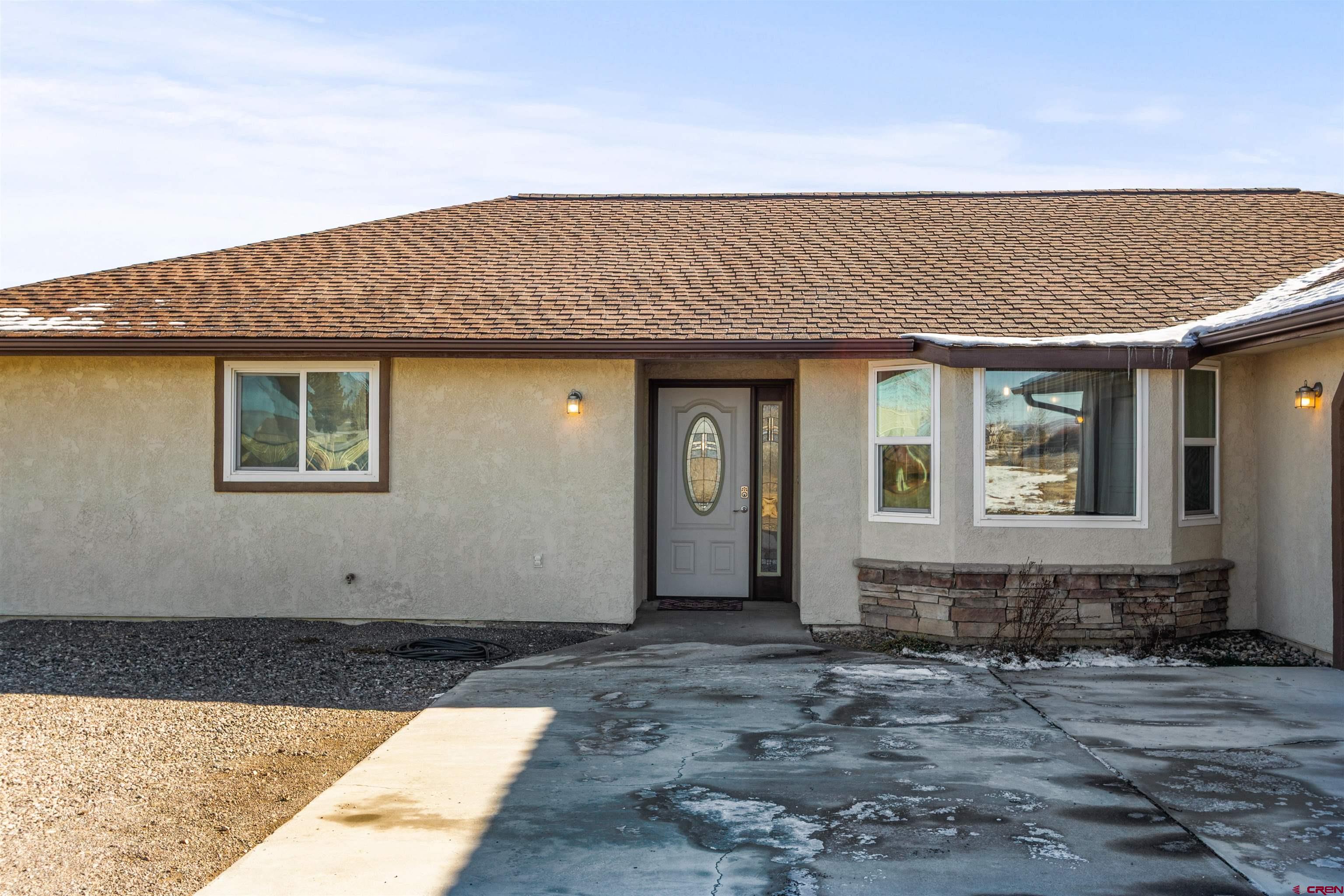 Welcome to 62920 Jeremy Rd—a place where space, comfort, and Western Colorado’s wide-open beauty come together. This well-cared-for 3-bedroom, 2-bath home sits on 1.42 acres, offering privacy without feeling isolated, plus extra living space that adds flexibility for everyday living, guests, or a home office.  Inside, natural light fills the home, enhanced by new windows that improve comfort and efficiency throughout. The fully remodeled kitchen is both functional and inviting, designed for real life—whether you’re cooking for a crowd or enjoying a quiet morning at home. The layout flows effortlessly to the backyard patio, perfect for relaxed evenings or entertaining while taking in views of the Adobes, the Black Canyon, and the Grand Mesa.  The fully fenced backyard creates a peaceful outdoor retreat with room for pets, play, and unwinding. Located in a friendly, walkable neighborhood, this home offers space to breathe, beautiful scenery, and the kind of comfort that simply feels right.