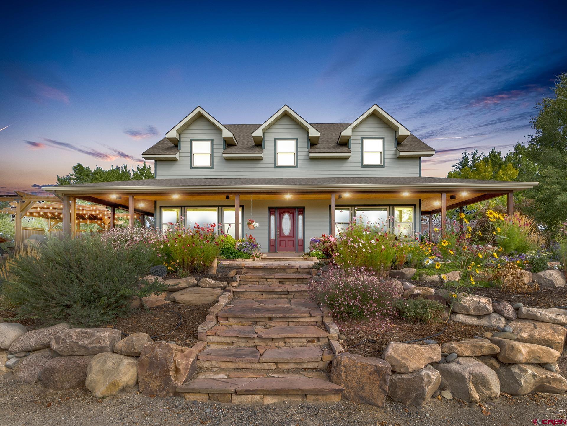 Beautiful 3600 sq. ft. Custom home on almost 5 private acres with irrigation water. Conveniently located between Delta and Montrose and buffered by a nice canopy of trees and set back off of Hwy 50 with good views of the San Juan Mountains. This property and home is beaming with pride of ownership and was developed with love and care by the original owners and has been an outstanding place to call home for the current Owners. Geothermal heating and cooling provide efficient and constant performance for year round comfort and lower energy bills! The cement siding was recently painted ensuring years of appearance and function. A wide array of flower arrangements from annuals to perennials adorn the exterior of the home with live water features that compliment the flagstone outdoor walking surface where you will find stylish horseshoe and cornhole setups, putting and chipping greens, sandbox for kids, relaxing fire pit area and a great outdoor covered BBQ area. Set the mood with all of the outdoor lighting and you will find yourself in a magical place as the sun sets. Open concept inside with real hardwood floors, rich wood cabinetry and solid surface counters. Massive Island centers the kitchen and dining area and often becomes a focal point. Master bedroom is on the main level with access to the covered wrap around deck. Upstairs includes three additional bedrooms, a big bonus room, good office space and a full bath. Have animals or 4H projects then look no further this property also has a nice barn to accommodate. 2 car attached garage. No HOA or Covenants. Come grab your slice of heaven!