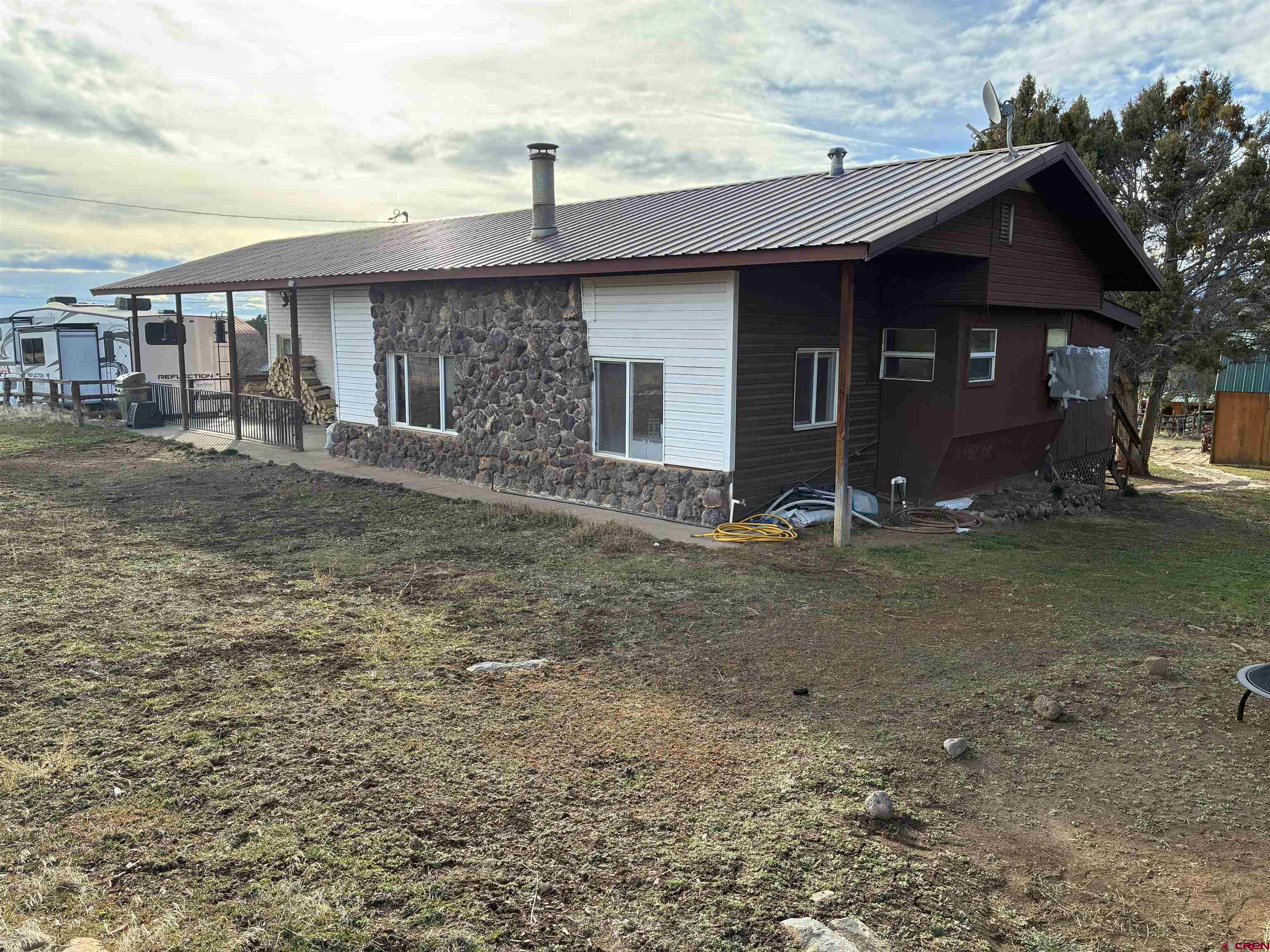 This inviting property is ideally located at the foot of the Grand Mesa, just a few miles north of Cedaredge, Colorado. The original manufactured home features a framed roof with an added living space and a comfortable covered deck—perfect for relaxing and taking in the mountain setting. Situated on 2.75 acres, the property includes several well-maintained outbuildings offering plenty of storage and flexibility. Whether you’re looking for a base camp for your Colorado hunting trips or a peaceful full-time residence, this property fits the bill. Enjoy easy access to the many lakes atop the Grand Mesa, known for excellent fishing and outdoor recreation year-round.