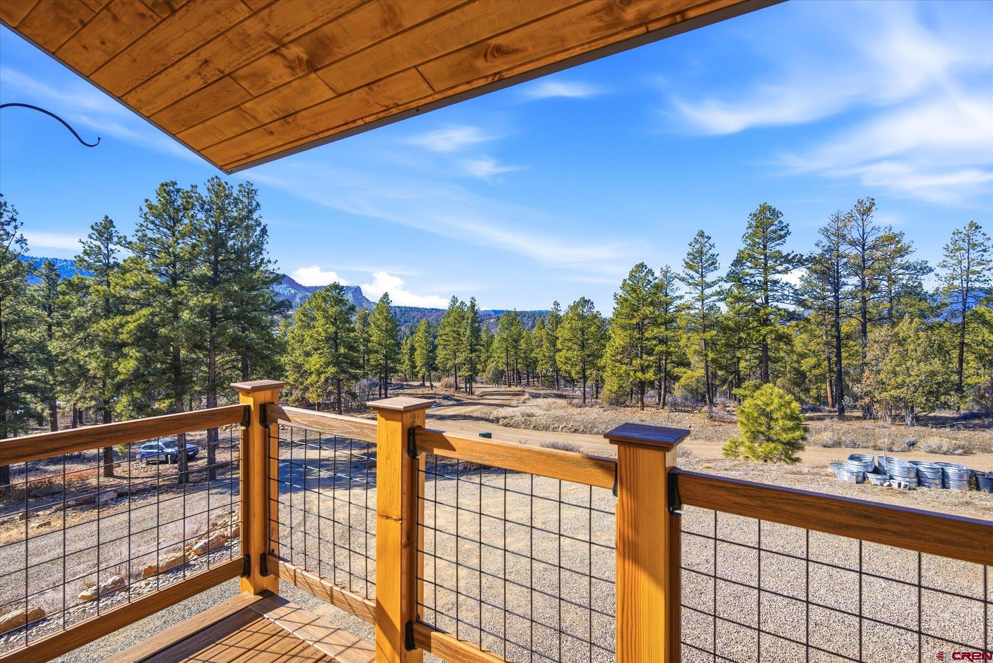 Set on just under four acres in the gated Elk Park Meadows community, this newer mountain chalet offers the rare combination of privacy, views, and easy access to town amenities in Pagosa Springs. With no close neighbors and sweeping views of Broken Off Point and Chimney Rock, this is Colorado mountain living done right, and poised perfectly for multi-generational living under one roof.  Built in 2021, the home features a thoughtfully designed residence with four bedrooms and three bathrooms, positioned to capture stunning scenery from the primary living spaces. High-end finishes include solid hickory cabinetry, quartz countertops, solid wood doors, and durable luxury vinyl plank flooring. Radiant in-floor heating runs throughout the entire home, including the oversized two-car garage, keeping every space warm and comfortable year-round. A wood-burning stove in the main living area adds ambiance and serves as an efficient supplemental heat source.  An attached in-law suite expands the home’s flexibility, offering a private living room, full kitchen, bedroom, and bathroom; ideal for multi-generational living, visiting guests, or extended stays. Both the main living area and the lower level feature wood-burning stoves & generous storage.  The low-maintenance exterior combines stucco and factory-coated siding, allowing you to spend more time enjoying the outdoors and less time on upkeep. A detached storage shed/toy garage with power provides additional space for recreation gear, tools, or seasonal toys.  Outdoor living is a highlight, with a large covered deck perfectly positioned to take in vibrant sunsets and expansive mountain views. National Forest access is nearby via subdivision roads, while Highway 160 and downtown Pagosa Springs are just minutes away. Offering quick access to dining, shopping, hot springs, and year-round recreation.