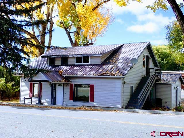 Charming Craftsman Style Home in the Heart of Cedaredge, currently being used for a business with offices and a rental apartment in the upper level, offers elegance, warmth and character – an exceptional opportunity for those seeking a distinctive residence with presence and convenience. Inside, you’ll find generous living spaces filled with natural light and period charm. Keeping in mind that the current use has been a business office, the Main Level encompasses 2 Bedrooms, 2 office/den type rooms, 3 other separate & distinct open room areas, 2 Half Baths, a Small Kitchenette and a Laundry Room/Storage Area. However, with a Creative Mind and a little reconfiguring, this level could be turned back into a charming family residence. In the Upper Level, there is a 2 Bedroom/1 Full Bath Apartment with a separate entrance, which could be used as a rental for extra income or additional family members. While the property sits in a commercially favorable location, it stands proudly as a gracious residence—perfect for someone who appreciates historic character combined with accessibility and visibility. This home offers the rare chance to own a piece of Cedaredge charm, blending classic Victorian beauty with modern-day possibilities. If you should decide you want to use the property as an investment or commercial opportunity, it offers a rare combination of commercial opportunity and residential comfort within one charming building. It brings together culture, creativity, and small-business energy—an ideal fit for Cedaredge’s welcoming community and growing entrepreneurial spirit. Whether you envision a vibrant gallery, an inspiring studio, a boutique storefront, or a charming residence with income potential, this Victorian treasure offers a unique opportunity to own a landmark property with limitless possibilities. Please watch the Video Tour for a better look at all the areas, including the upper apartment.