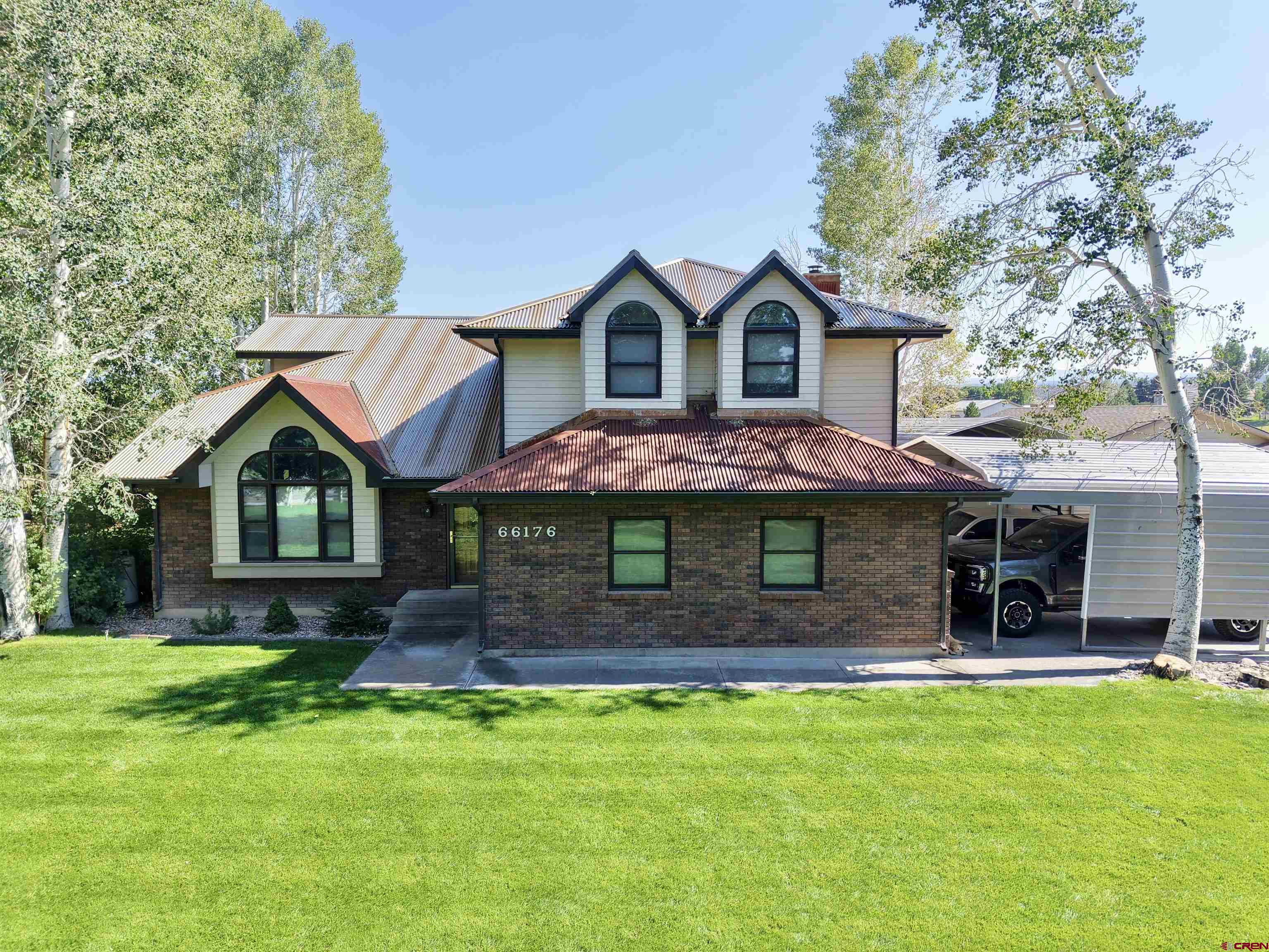 Discover your slice of convenient country living just south of Montrose. A rare opportunity to own a thoughtfully updated home on just under 4 acres with breathtaking south-facing views across open pastures to the majestic San Juan Mountains. This charming 4-bedroom, 2.5-bathroom residence offers 2,216 square feet of comfortable living space, highlighted by stunning hardwood floors that flow through the main areas, creating a warm and timeless ambiance. Recent upgrades include a brand-new metal roof (2025) for lasting durability and brand-new granite countertops (2025) that elevate the kitchen to modern tastes. Step outside to enjoy beautiful mature landscaping that surrounds the home, providing privacy, shade, and year-round appeal. With no HOA or covenants to restrict your lifestyle, this property is perfectly set up for horses or any other animals complete with irrigation water rights to keep the pastures green and productive. The attached 2-car garage offers everyday convenience, while the additional detached garage/workshop features a wood-burning stove, 220 power, and multiple doors providing abundant storage for vehicles, equipment, hobbies, or livestock needs. Just minutes from the south Montrose shopping center, you’ll enjoy easy access to amenities while embracing the peaceful, open feel of rural living with panoramic mountain vistas right from your doorstep. Whether you’re seeking a family homestead, a hobby farm, or a serene retreat with room to roam, this home delivers the best of Western Colorado living…Call today for your private showing!