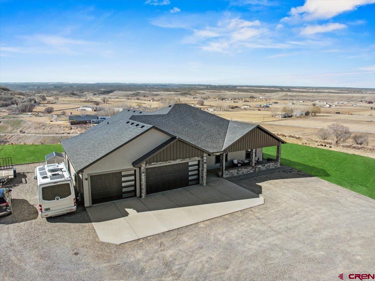 Experience turnkey modern country living in this 2024 contemporary ranch perched on a private 5.1-acre parcel with sweeping San Juan Mountain views. The 2,293 SF open floorplan includes 3 bedrooms and 2.5 baths, a chef’s kitchen with premium finishes and set up for gas or electric, large windows framing dramatic vistas, and quality fixtures throughout. The Garage has plenty of room for a truck, car and toys.  Exterior materials of stucco and stone provide low-maintenance curb appeal. The property has irrigation water, sprinkler system , hot tub set up and no HOA. Enjoy striking morning sunrises and evening sunsets from multiple vantage points. There is ample room for a large shop with an ADU. Close to outdoor recreation via the Westside trailhead and BLM lands, while downtown Montrose amenities are only minutes away. Move-in ready and ideally suited for buyers seeking privacy, functionality and spectacular views. Enjoy endless outdoor activities in the area from the Grand Mesa to Telluride all in a day trip distance.