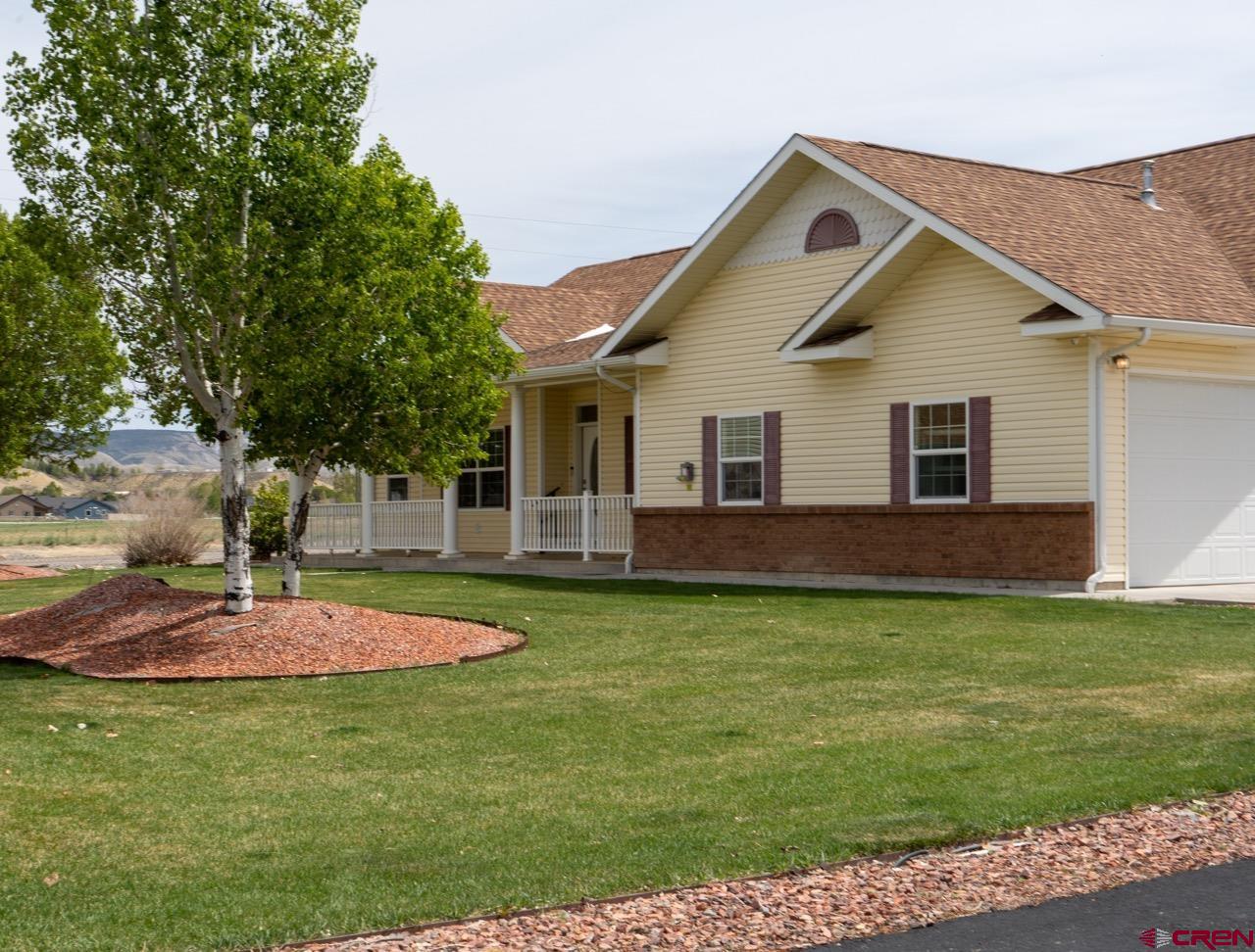 This beautifully maintained 3 bedroom, 2 bathroom home is situated on 4 acres, with 3 irrigated acres in the heart of Montrose. Built in 2004, this 2,226 square foot home offers a perfect blend of comfort, functionality, and the Western Colorado lifestyle. Featuring valuable irrigation water rights through UVWUA and easy maintenance with a RainBird sprinkler system, this property is ideal for creating your own Colorado ranchette. With no HOA or covenants, you are free to set up pens for livestock and horses, or leave room for other outdoor hobbies. The property includes both an attached garage and a 1,024 sqft detached garage/shop with a full RV hookup, making it perfect for extra vehicles, recreational toys, or workshop space. Enjoy the convenience of a paved driveway for easy year-round access, and take in the breathtaking panoramic views of the San Juan Mountains and Cimarron Range right out of your window and patio. Additionally, the home is equipped with paid-for solar panels and a geothermal system, significantly lowering monthly living costs. Located just minutes from shopping, dining, schools, and medical facilities, this property offers peaceful country living with in-town convenience. Outdoor enthusiasts and families will appreciate being approximately 65 miles from world-class skiing at Telluride Ski Resort, along with nearby access to schools, Montrose Regional Airport, hiking, fishing, hunting, and endless year-round recreation. Some photos have been virtually staged as noted. Seller is offering Sellers Concessions.