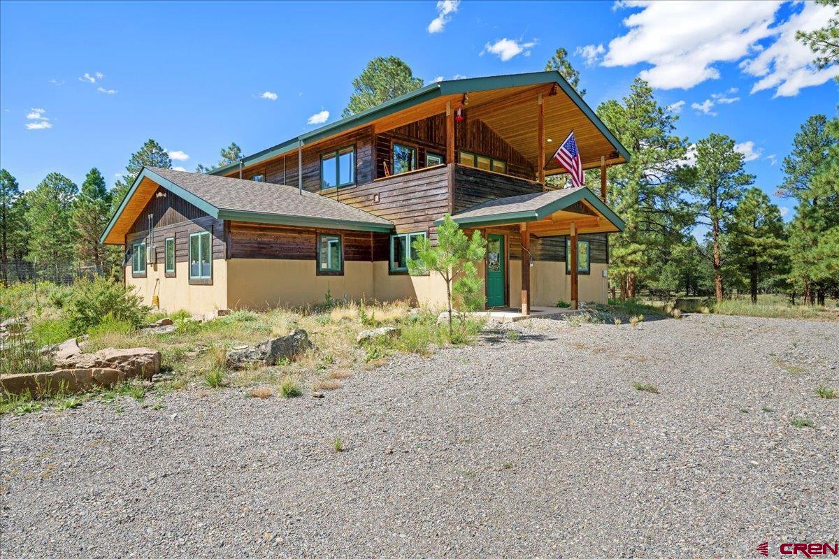 Discover your dream property in the heart of Ridgway, Colorado! This stunning 2,914-square-foot custom home, among tall Ponderosa Pine trees, built in 2002, was designed with quality, comfort, and sustainability in mind. Constructed with energy-efficient SIP panels, the home features radiant floor heating and a cozy wood-burning stove—perfect for chilly Colorado evenings. Recent upgrades include new paint throughout, elegant tile flooring, and bamboo floors throughout the main living areas, seamlessly blending timeless style with modern comfort. Solar panels and LED lighting help reduce utility costs, while a highly productive private water well ensures reliable, cost-effective water. Step out onto the upper-level deck to take in the breathtaking views or entertain guests. The upper level features a kitchen with updated stainless steel appliances, a pantry, vaulted ceilings, and a wood-burning stove. The primary bedroom offers a walk-in closet with abundant storage and natural light, and the bathroom includes new lighting, a shower enclosure, and a double-sink vanity. The lower level boasts a spacious studio that can serve as an additional bedroom, family/media room, mother-in-law suite, or hobby/craft area. The laundry/mud room includes a utility sink, ample cabinetry, and direct outdoor access. A large unheated storage room with shelving and a wine cellar enhances the home’s functionality. A brightly painted bathroom features a shower enclosure and excellent lighting, while the additional bedroom and office benefit from high-speed Clearnetwork Fiber Internet. Perfectly located near the Divide Golf Course, the property balances activity and leisure. Montrose Regional Airport is just 38 minutes away, with Telluride only 58 minutes distant—offering both convenience and privacy. Adding tremendous value, the property includes a massive 1800-square-foot workshop/garage built with energy-efficient SIP panels. Measuring approximately 32x56 feet, it offers covered parking on both sides, in-floor heat, a wood-burning stove, 220V power, a half bath, and two 12-foot overhead doors—ideal for hobbies, storage, or a serious workshop. Surrounded by breathtaking mountain views, this property delivers the perfect combination of privacy, space, sustainable features, and versatility. Whether you’re seeking a permanent residence, a mountain getaway, or a property with extensive work and storage options, this Ridgway gem is a rare opportunity to own a true Colorado retreat.