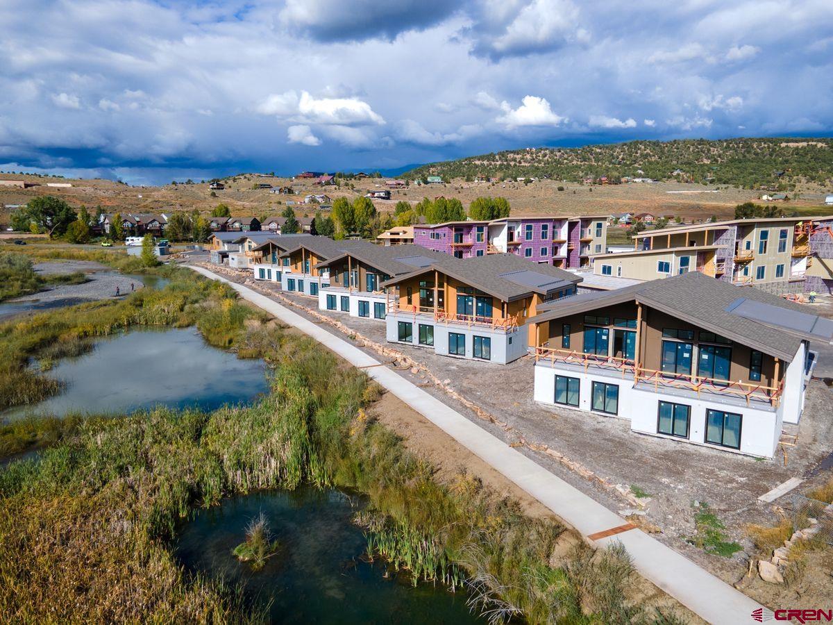 Three Duplexes left on the River.   Placed in an ideal location along the banks of the Uncompahgre River, Riverfront Village offers the only riverfront residences in the town of Ridgway. Open space across the river brings privacy and tranquility to residents. These mountain modern condominiums and duplexes range from 2 to 3 bedrooms and include 2-car garages. They also boast alpenglow vistas to the east and evening sunsets dancing across the river to the west. Natural textures are complemented by warm, neutral accents for the perfect blend of polish and comfort. Walk, bike, or jog along the recreation path that leads from Riverfront Village to downtown dining and shopping options as well as Ridgway State Park and Ridgway Reservoir. Nestled in the Uncompahgre Valley ringed by the Cimarron Mountains, call Ridgway Home. There may be additional units available that are not in the MLS, please inquire about more opportunities to own at Riverfront Village.