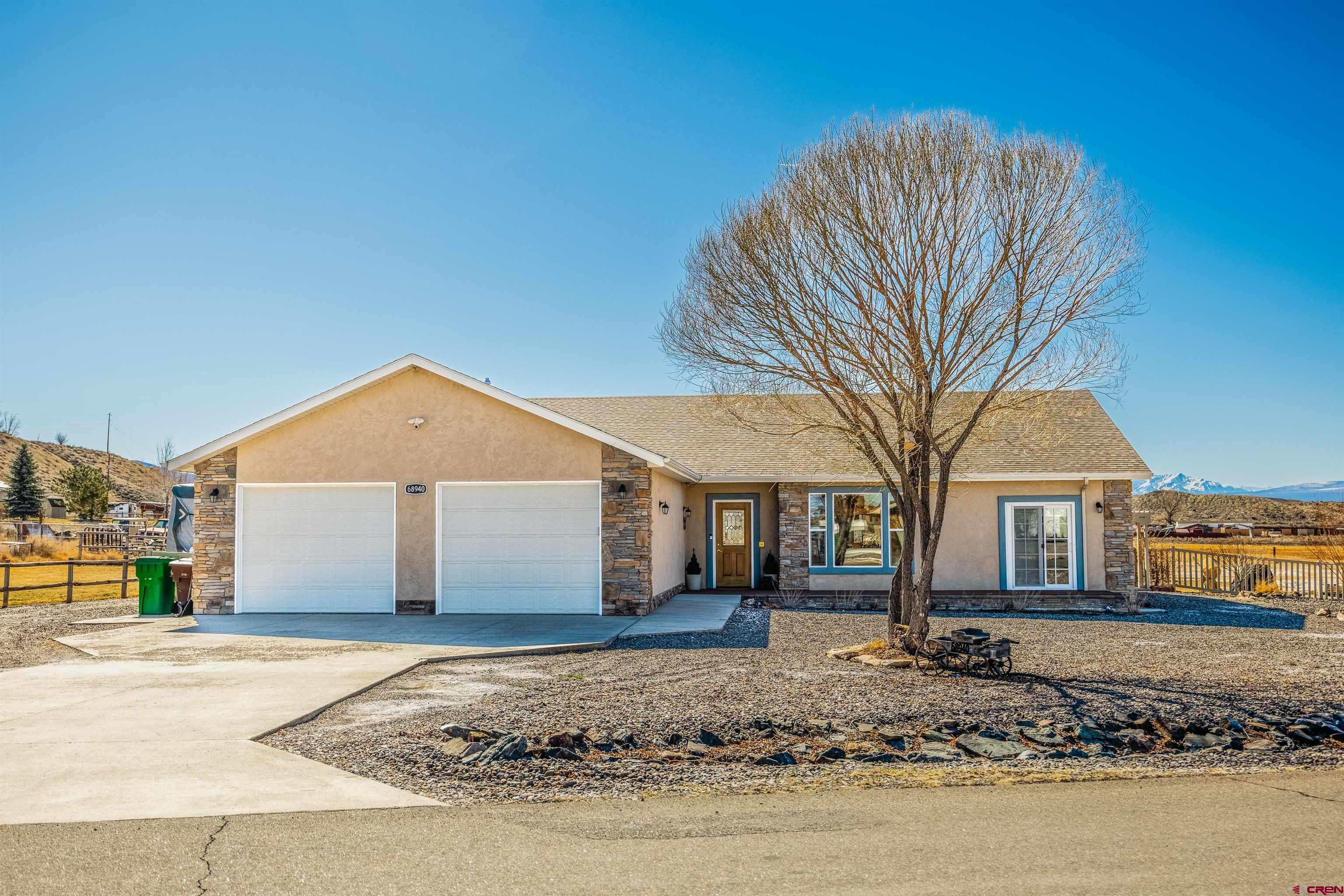 Welcome to this inviting home in the desirable Meadowgate subdivision of Montrose, Colorado—offering comfort, space, and beautiful surroundings in one attractive package. Set on just over 1.5 irrigated acres in the country - but convenient to town - the property features expansive views of the San Juan Mountain Range, plenty of room for vehicles, trailers, and recreational toys, and a yard perfectly suited for hobby-farm living if that's your preference! The exterior includes dedicated RV parking with electrical hookup and RV dump, giving you the flexibility to host guests or store your travel setup with ease. The spacious acreage also provides room to garden, keep animals, or simply enjoy the wide-open Western Colorado lifestyle. Inside, the home is filled with natural light and warm neutral tones. Recent updates include all-new engineered hardwood hickory flooring, as well as a brand new furnace, providing durability and a sense of confidence. The thoughtful layout features three bedrooms with ensuite baths, plus a versatile office/den/flex room that can easily adapt to your needs. The open living, kitchen, and dining area creates a welcoming central space ideal for everyday living and entertaining. The main primary suite is a relaxing retreat, offering generous storage, an additional flex space, a full walk-in closet, and a spacious primary bathroom. If you're looking for room to breathe, stunning mountain views, and a home that blends comfort with functionality, this property delivers. Schedule your showing today and discover a place you’ll be proud to call home.