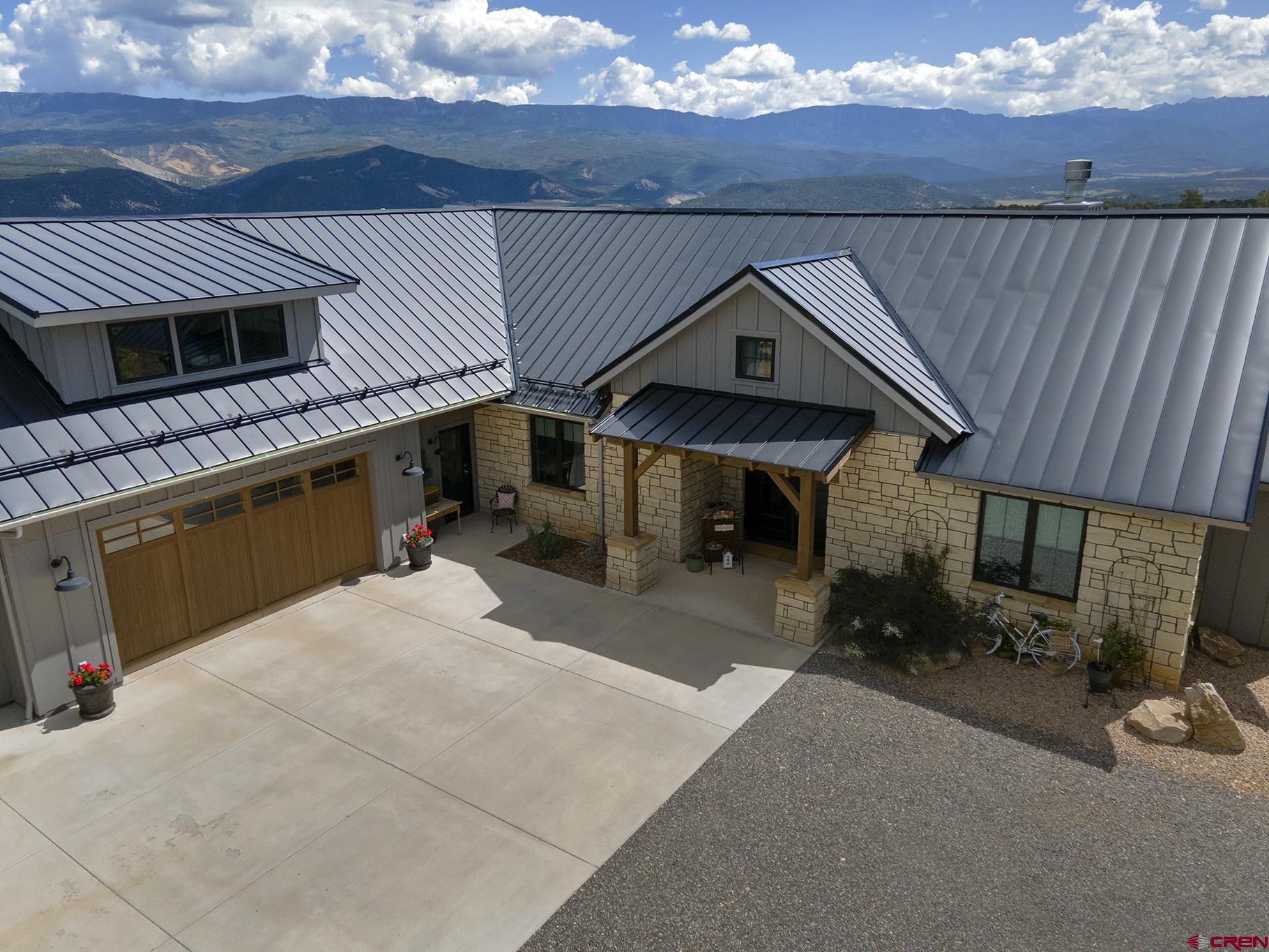 Don't miss this stunning Log Hill home situated on over four acres, thoughtfully designed to maximize the unobstructed Cimarron views and constructed by renowned local builder, DCI Construction in 2020. Light and bright, the open concept great room showcases a stone fireplace with a mantle fabricated from wood salvaged from an Ohio log cabin. The gourmet kitchen features designer cabinets, an expansive island, and high-end appliances. The primary suite has Cimarron views, a steam shower, claw foot tub and an oversized walk-in closet located right next to the large laundry room. Enjoy three main floor bedrooms and a non-conforming bedroom/office/study with views of the Sneffels range above the extra deep three car garage.  The covered patio takes in all that the Colorado lifestyle has to offer and is perfect for entertaining and taking in the evening Alpenglow.  Hickory engineered wood floors with radiant heat create depth throughout this efficient, solar powered home. The two guest bedrooms, adjoined by a Jack and Jill bathroom, round out this architectural treasure. If you are searching for an unprecedented view and a comfortable, turnkey showcase, look no further!