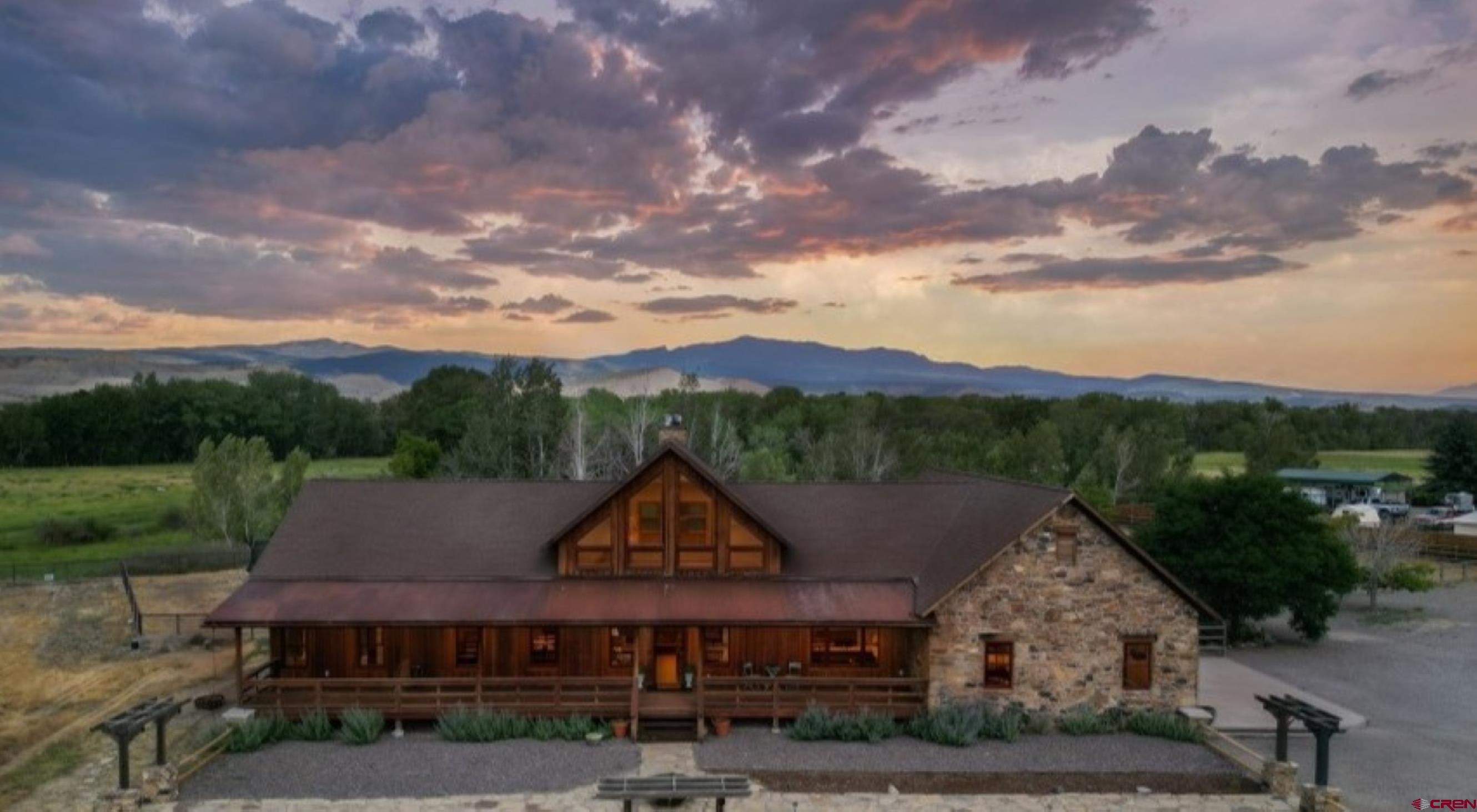 Every detail of this custom-built home has been thoughtfully crafted, evoking the charm of European architecture with textured walls, vaulted ceilings, and a stunning 2 story floor to ceiling, double-sided stone fireplace—perfect for cozy evenings indoors or fireside gatherings on the back covered porch. The cook’s kitchen is designed to bring everyone together, featuring a gas stove, double oven, two lighted pantries, and a large preparation island with a butcher block top. The concrete countertops add warmth and character, beautifully complemented by a large porcelain country sink, creating a space that is both functional and inviting for entertaining or everyday living. The backyard feels magical, offering sweeping views of Storm King Mountain framed by mature cottonwoods. A variety of birds bring a peaceful melody to the property, and bald eagles often grace the meadows beyond the fence—creating a serene sanctuary surrounded by nature. From the Primary Suite, step out through French doors to your private deck there is a hookup for a hot tub to sit beneath the stars. The primary bathroom offers a relaxing retreat with a jetted tub, perfect for soaking after a long day while enjoying the peaceful surroundings. Inside, the home blends elegance with practicality. The Primary bedroom is thoughtfully situated near the secondary bedrooms, offering peace of mind and comfort for families. Expansive windows fill the space with natural light, while the open layout invites warmth and connection. A huge upstairs loft with its own bathroom offers incredible versatility and privacy. This space could easily serve as a guest suite, home office, exercise room, or additional bedroom—perfect for visitors, remote work, or multi-generational living. The property offers abundant space and versatility. The front acreage is a blank canvas, ready to be irrigated for lush grass, gardens, or additional trees. A newly built pipe perimeter fence provides durability and security, while a fenced corral with a two-stall shed creates an ideal setup for animals or hobby farming. The spacious three-car garage includes dedicated work areas, offering plenty of room for projects, storage, tools, and recreational equipment. Additional storage throughout the home—including generous closets, large crawl spaces, and an attic above the garage—adds everyday convenience. If you’ve been dreaming of the perfect hobby farm just south of Montrose and only minutes from town, this property offers the ideal blend of rural serenity and accessibility. Set on expansive land with breathtaking views and endless opportunities, this home harmonizes elegance, function, and natural beauty—a true sanctuary for those who appreciate craftsmanship, privacy, and Colorado’s incredible landscape. 5th bedroom is a large loft with it's own bathroom but has no closet.
