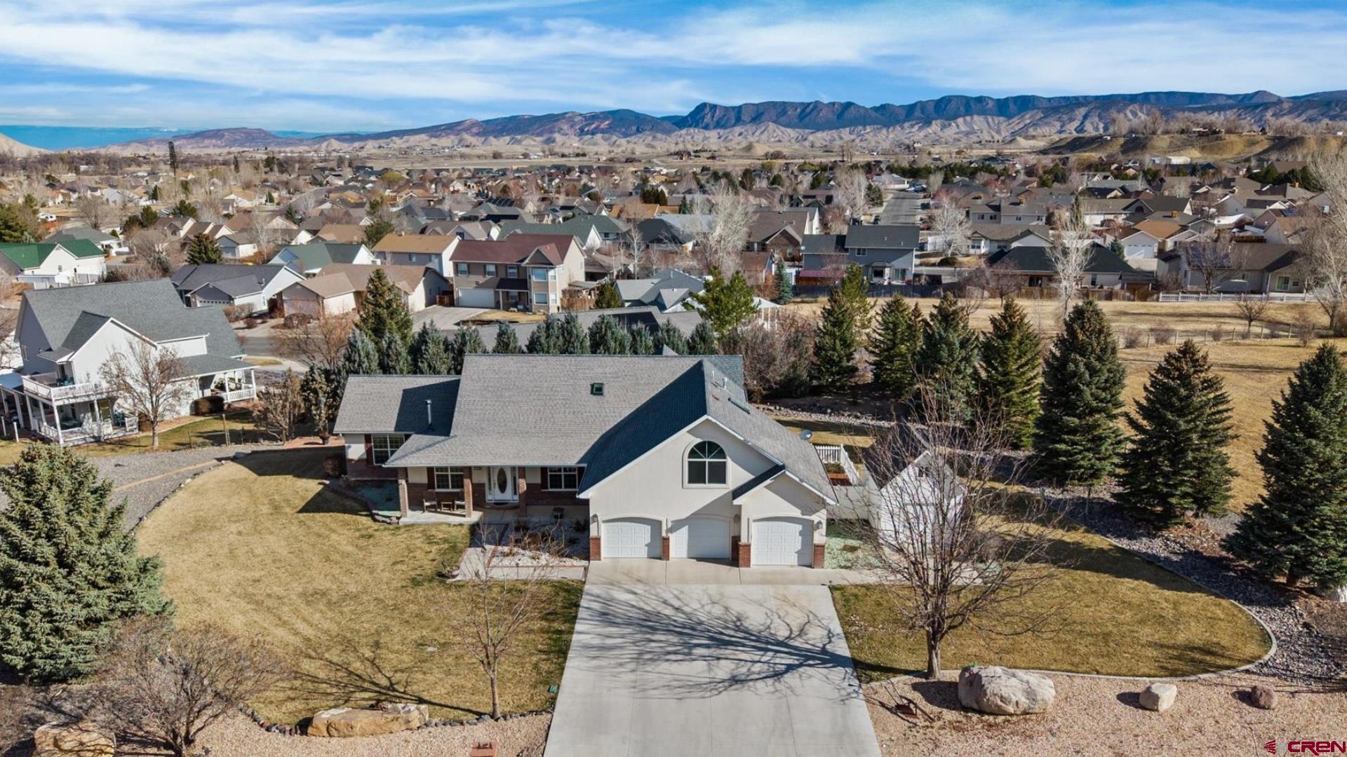 Show-Stopping, Spectacular Custom Home With High-End Finishes, 30' by 50' Shop, Perfect Floor Plan, And All in One of the Most Prestigious and Sought After Neighborhoods in Montrose, Colorado. Nestled on over an acre in Fox Hills, this property embodies everything that makes living in Western Colorado so good. A sprawling, well-designed floor plan delivers a main floor en-suite, as well as multiple living accommodations for whoever you're bringing with you. Step inside and enjoy gorgeous hardwood floors, uniting excellent living spaces with streaming natural light and an open-concept layout. The kitchen has been tastefully remodeled and delivers knotty alder cabinetry with pull-out drawers, a massive island and eat-in bar, under cabinet lighting, a large pantry and an ergonomic layout, making every day life practical and easy. Enjoy two living rooms, one with a fireplace and one with a wood stove, allowing endless options for hosting, and living your life the way you want. The main-floor en-suite has private access to the backyard, a huge walk-in closet and walk-in shower. The main floor also includes an additional bedroom, which could be perfect for a home office or gym. Upstairs provides versatile living spaces with a bonus room and full bathroom, as well as additional bedrooms to accommodate whoever you're bringing with you, or to provide your guests privacy and comfort when they visit. Added benefits are an extra wide and deep, 3-car garage which cuts no corners and will accommodate large vehicles. Imagine next-level peace and relaxation with your favorite beverage in hand surveying your 1+ acre paradise, with a stunning yard, beautiful treed views, walking paths, and endless potential for transforming and enjoying it however best suits you. The main event could be the shop, which you'll find will easily store and protect massive RV's, and could be utilized to house project cars, ATV's, boats, and all the toys you will own to make the most of your Colorado lifestyle. An additional large storage shed is ideal for lawn equipment and excess gear, and a hot tub and private backyard are just waiting for your enjoyment. This home couldn't be in a better location; protected and tucked inside a beautiful and upscale neighborhood, while being just minutes from curated cuisine, unmatched healthcare, a world-class recreation center, and all the best shopping and amenities Montrose has to offer. Discerning covenants to ensure your value while still allowing you freedom and flexibility, you will absolutely fall in love with this property inside and out. Make the Western Colorado Dream a Reality, Experience it For Yourself Today!