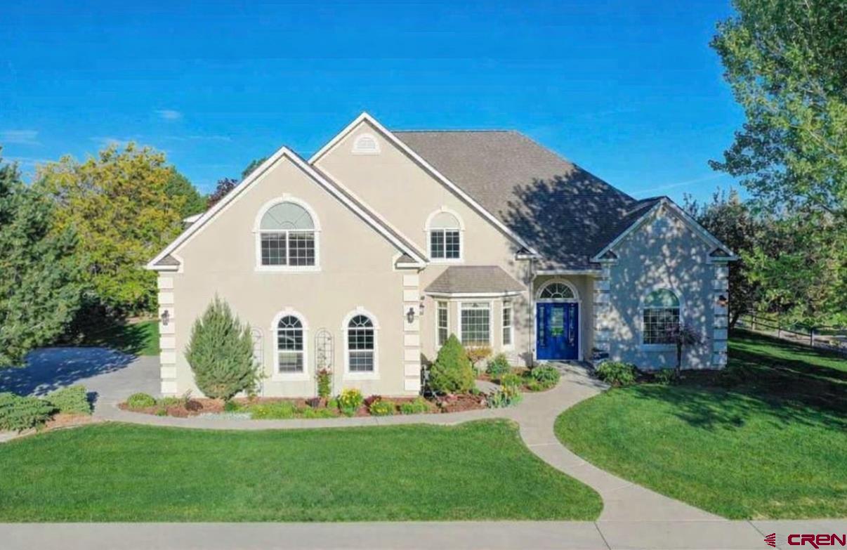 The opportunity you’ve been waiting for has arrived! Quality and durability coupled with elegance and luxury in this exquisite 5-bedroom, 4-bathroom custom residence, spanning an impressive 4,901 square feet in the highly regarded Otter Pond subdivision. Boasting exceptional curb appeal with beautifully landscaped mature grounds and open space directly behind the home, this property offers privacy, serenity, and convenience all in one. Step through the grand, inviting foyer and immediately be captivated by the beautiful hardwood floors that flow throughout the main level. To the left is a spacious formal dining room featuring custom built-in cabinetry, seamlessly connecting via a butler’s pantry to the expansive eat-in kitchen—perfect for hosting large gatherings and social events. The chef’s kitchen is a true highlight, equipped with premium granite countertops, an additional pantry, dual ovens, and dual sinks for ultimate functionality. The foyer and kitchen naturally lead to the expansive main living room, where tall ceilings create an airy, open atmosphere ideal for a variety of furniture arrangements. A natural gas fireplace on the exterior wall adds warmth and ambiance year-round. Rarely found in today’s homes is the dedicated main-floor office with extensive custom built-ins, providing a high-end and useful workspace. Retreat to the one-of-a-kind primary suite, a spacious sanctuary with direct access to the back patio. The thoughtfully designed main level promotes comfortable, easy living, including a generous laundry room just beyond the kitchen, complete with ample storage cabinets for all your essentials. Upstairs, discover abundant versatility with four additional bedrooms, two bathrooms, and storage galore. Two bedrooms feature ensuite access, while all rooms offer generous proportions and flexibility—ideal as guest suites, a home schoolroom, library, craft space, fitness room, or more to suit your lifestyle. Practical luxury continues with an oversized 3-car garage and thoughtful storage solutions throughout, ensuring everything has its place and space is not wasted. Beyond the home, embrace the Otter Pond lifestyle: enjoy non-motorized water recreation and catch-and-release fishing on the stocked 15-acre neighborhood pond, utilize the community boathouse for limited storage, play on the tennis/pickleball court, or stroll the scenic walking paths and enjoy the wildlife in the area. This prime location delivers unmatched convenience, with easy proximity to the Montrose Recreation Center, Cottonwood Elementary School, grocery stores, medical offices, restaurants, and all essential shopping. Experience the perfect blend of high-end craftsmanship, thoughtful design, and resort-like amenities in one of Montrose’s most sought-after neighborhoods. Don’t miss this rare opportunity—call today to schedule your private showing!
