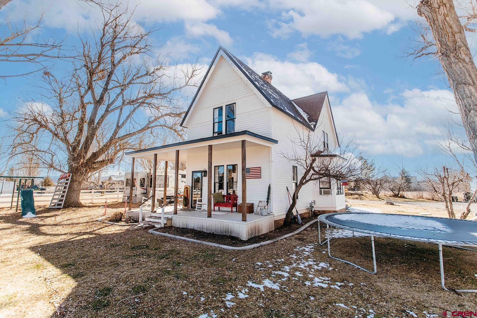 Spring Creek Farmhouse on 1 Acre | Water Rights, Fruit Trees & No HOA – 10 Min to Downtown Montrose. Welcome to your own private oasis in Montrose, Colorado. Situated on 1 acre in the coveted Spring Creek area, this charming 5-bedroom, 2-bathroom farmhouse (2,056 sq ft) offers peaceful country living just 10 minutes from downtown Montrose. The downstairs was beautifully remodeled in 2022, blending modern comfort with classic farmhouse character. The property includes 1.1 shares of water plus a well with more than enough supply for all your needs, making it ideal for gardening, landscaping, and enjoying the lush surroundings. Mature shade trees, fruit trees, a garden area, and a chicken coop create a true Western Slope homestead feel. With no HOA or covenants, there’s plenty of room for kids, pets, and outdoor living. Rich with Montrose history, this unique property offers abundant water, privacy, space, and the rare opportunity to own a beautiful creekside retreat close to everything Montrose has to offer. Contact your preferred agent today to see!