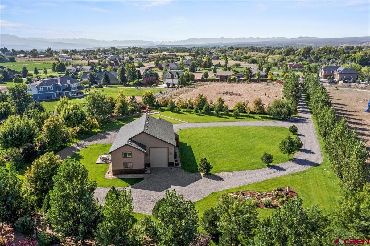 This personal retreat is a rare Colorado gem. Placed in one of the most desired areas this property sits on two acres providing multiple options to expand, build, and customize to your liking! It combines functionality, comfort, and natural beauty in one extraordinary setting. At its heart is a large, versatile shop perfect for hobbies, or storage paired with a private well-designed small apartment that offers practical living with exciting possibilities for the future. Perfect for outdoor enthusiast or anyone seeking a one-of-a-kind Colorado lifestyle. What truly sets this apart is the breathtaking meticulous landscaping. Every detail has been thoughtfully curated to create a serene, park-like environment.  Designed for both beauty and sustainability, the property features a state of the art irrigation system that keeps lawns lush and flowerbeds vibrant throughout the seasons. Follow a lighted walkway path to the highlight area of serenity with a firepit and a stunning custom- designed copper waterfall as the focal point to enjoy. This property offers an opportunity to build your dream home and make it your own!