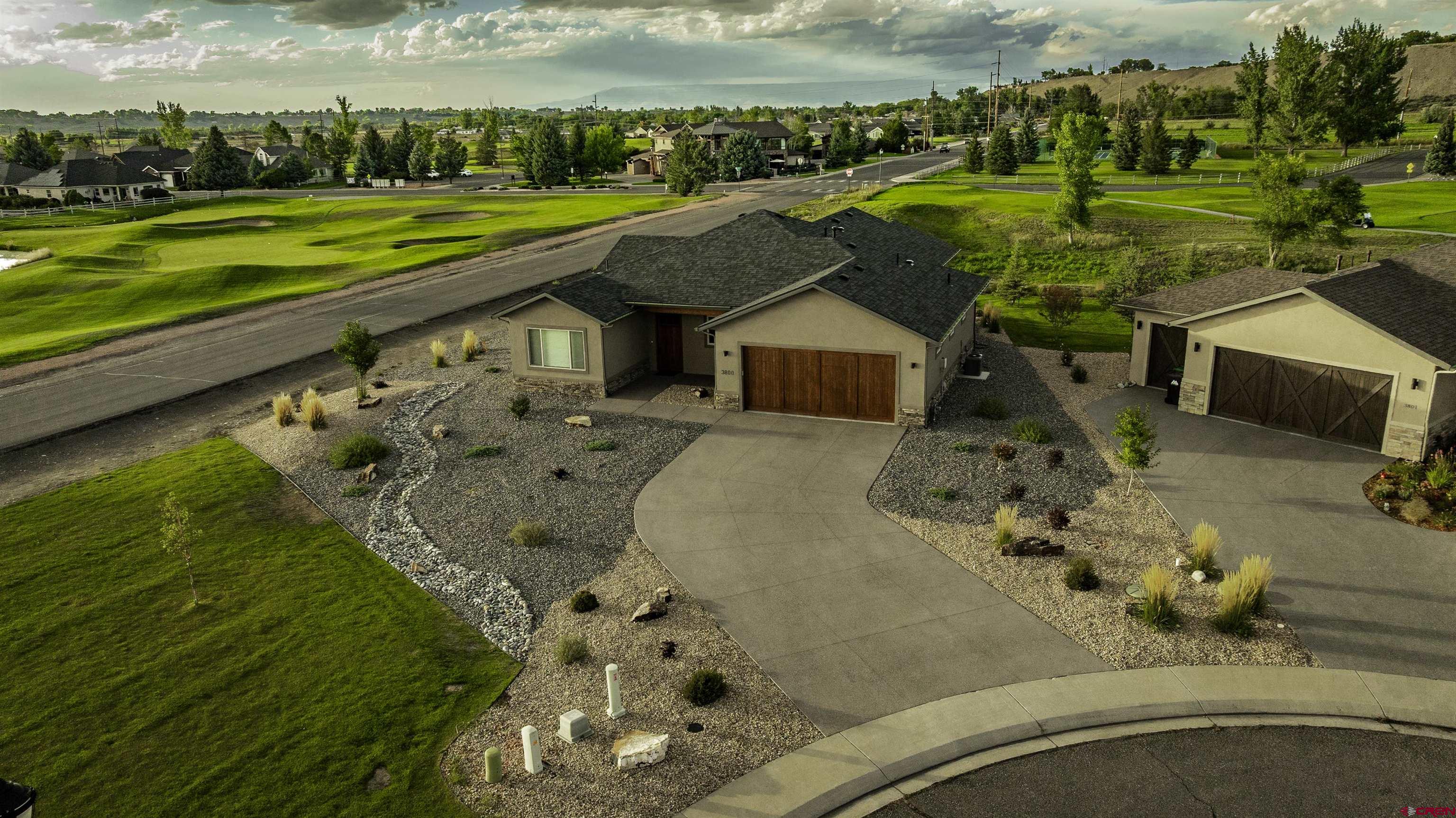 Nearly new luxury patio home located on a quiet cul-de-sac in the highly desirable Cobble Creek Golf Community. Built in 2022 and maintained in pristine condition, this beautifully designed single-level home offers the perfect combination of style, comfort, and low-maintenance living.  The thoughtfully designed floor plan features 1,796 square feet with 3 bedrooms and 2 bathrooms, including a flexible third bedroom that works perfectly as a home office or guest space. The open-concept living area is filled with natural light and flows seamlessly between the kitchen, dining, and living spaces—ideal for both everyday living and entertaining. The well-appointed kitchen features granite countertops, quality cabinetry, and modern finishes throughout.  Designed with privacy in mind, the primary suite is thoughtfully positioned on the opposite side of the home from the guest bedroom and bath, creating comfortable separation for visitors or a home office. The spacious primary suite includes a large walk-in closet and a private bath designed for comfort and convenience. Custom Hunter Douglas window coverings throughout the home add both style and functionality, complementing the modern finishes while providing excellent light control and privacy.  Situated on a generous 0.30 acre lot bordering the golf course, the property offers peaceful views toward the 1st fairway, tennis and pickleball courts and clubhouse area, creating a beautiful backdrop for relaxing evenings or entertaining on the patio.  The home is also just a short walk to the Cobble Creek clubhouse, where residents enjoy dining and drinks, a fitness center with sauna, and a vibrant calendar of social events and activities.  As a Cobble Creek patio home, the property offers true lock-and-leave convenience with irrigation, lawn maintenance, and snow removal managed through the HOA—perfect for those seeking a low-maintenance lifestyle or a second home in Montrose.  Residents enjoy access to the exceptional amenities of Cobble Creek including the clubhouse, fitness center, tennis courts, park, and optional golf memberships. Cobble Creek Club membership transfers to the buyer at closing, offering immediate access to the community lifestyle.  This is a rare opportunity to own a nearly new, move-in-ready patio home in one of Montrose’s premier golf communities.