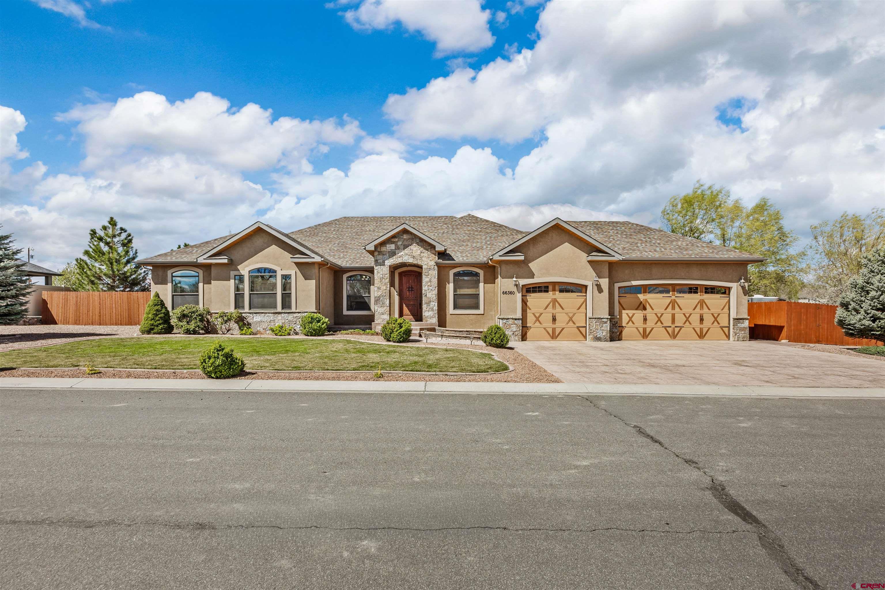 Originally built as a personal residence by and for a luxury home builder, this one-of-a-kind home is a showcase of craftsmanship, intention, and elevated living—where no detail was overlooked and no corners were cut.      From the moment you arrive, the curb appeal sets the tone with mature trees, stamped and sealed concrete, and a striking blend of stone and stucco. Step through the solid wood entry and into a home designed to balance comfort, function, and refined style.      Inside, you’ll find a thoughtfully designed split floor plan, expansive natural light, and high-end finishes throughout. The heart of the home offers an inviting living space anchored by a gas fireplace, flowing seamlessly into a beautifully appointed kitchen featuring custom cabinetry, double ovens, generous prep space, and a layout ideal for both everyday living and entertaining.      The primary suite is a true retreat, complete with a lit tray ceiling, spa-inspired bath with travertine finishes, an enclosed shower, oversized jetted tub, and a peaceful atmosphere designed for relaxation. Beyond the interior, this property truly shines. Step outside to an exceptional outdoor living experience—tiled patios, roll-down shades, integrated lighting, gas stub for grilling, and a fully fenced backyard designed for both privacy and enjoyment. Whether hosting guests or enjoying a quiet Colorado evening, this space delivers. For those needing room for hobbies, toys, or workspaces, this property goes above and beyond: - A fully finished, heated shop with multiple 220V outlets and loft storage - RV parking with 50-amp service (grandfathered within the HOA) - Oversized garage with room for larger vehicles and added functionality The grounds are meticulously maintained with full irrigation, drip systems for all landscaping, and a mature orchard featuring cherry, apple, peach, pear, and chokecherry trees—creating a setting that is both beautiful and productive. This is more than a home—it’s a fully engineered lifestyle property. Due to the extensive list of upgrades, features, and thoughtful enhancements, a detailed property features sheet is available upon request.