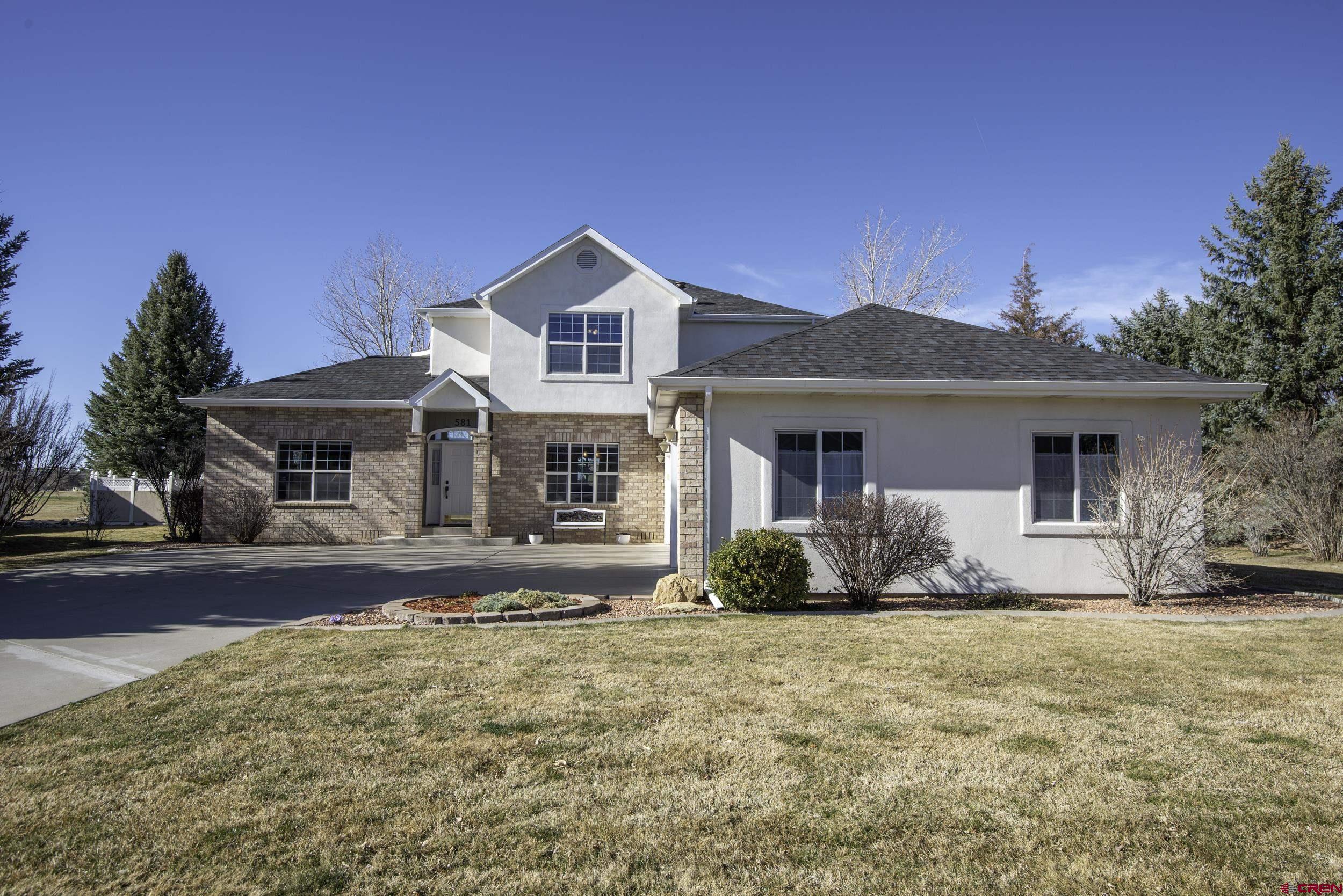Welcome to this beautifully maintained two-story contemporary home located in the sought-after Cobble Creek Golf Community. Perfectly positioned along the fairway of Hole #10, this property offers stunning open views of the Grand Mesa and a peaceful golf course setting. Built in 2000, this 3-bedroom, 2.5-bathroom home with a spacious three-car garage combines comfortable living with thoughtful updates throughout. Inside, you’ll find two inviting living spaces designed for both relaxation and entertaining. The main living room features a cozy gas fireplace, while a second living area just off the kitchen provides a welcoming gathering space with direct access to the backyard, deck, and patio. The kitchen has been enhanced with high-end appliances, including a Wolf range and Thermodor microwave (2021), making it a great space for everyday cooking or hosting guests. The large dining room window highlights the tray ceiling and beautiful hard wood floors. Upstairs, all three bedrooms are thoughtfully arranged for privacy. The well-proportioned primary suite offers a private ensuite bathroom and a walk-in closet. Two additional bedrooms with walk-in closets and a full bathroom complete the upper level. Recent upgrades provide peace of mind and modern appeal, including: a new roof (2022), interior and exterior paint (2022), and new heating and air conditioning system (2025). With its golf course frontage, Grand Mesa views, and numerous recent improvements, this Cobble Creek home offers the perfect blend of comfort, scenery, and lifestyle. The Cobble Creek Club membership includes regular social gatherings, access to the fitness and weight rooms, men’s and women’s coffee, card games, mah jong, poker night, pickleball, hiking club, tavern discount, golf discount and more. It's a great community to be a part of!