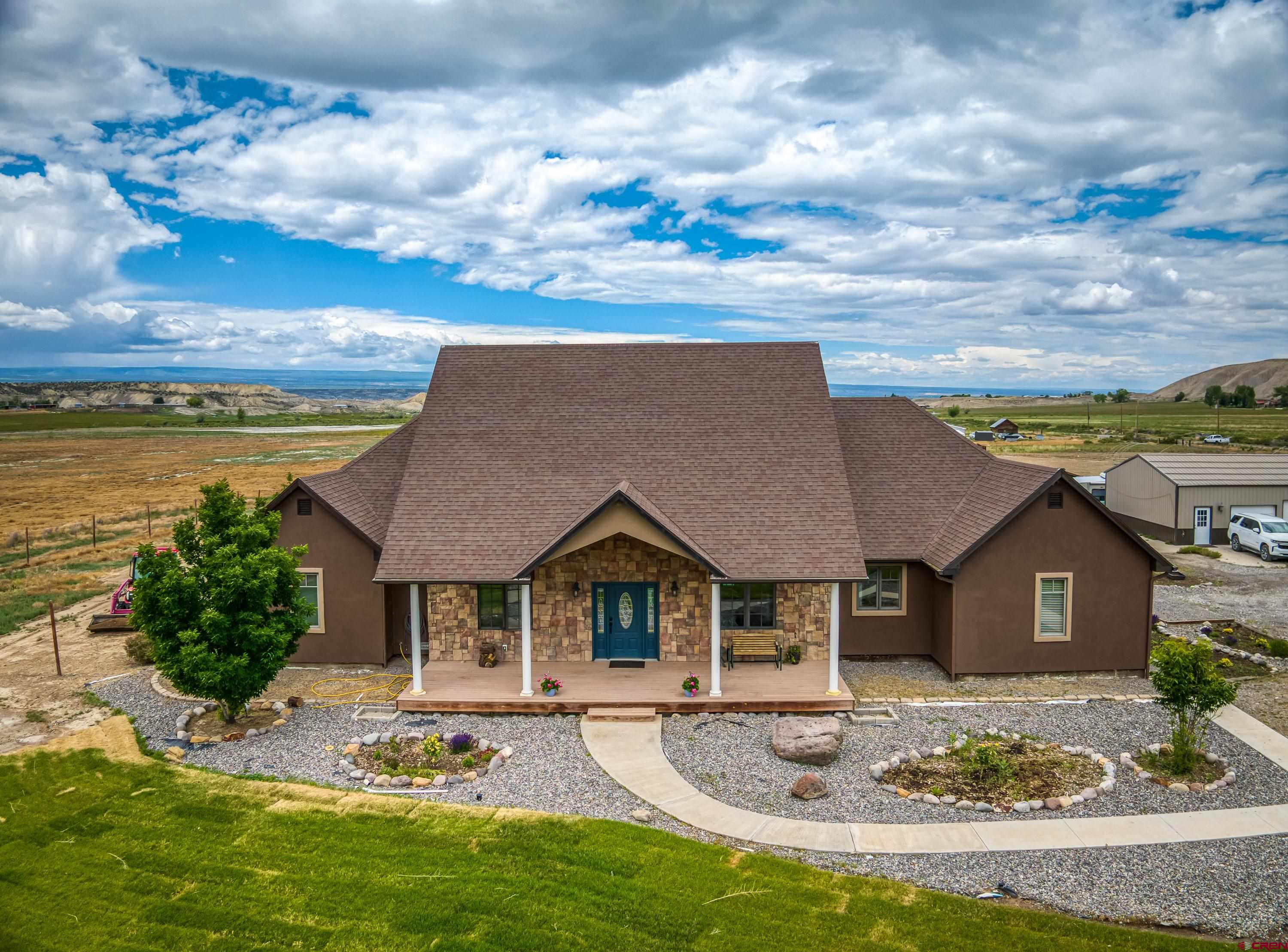 Enjoy the space and flexibility this remarkable custom home offers on 11.62 acres. The property features newer granite countertops in the kitchen, along with fully remodeled bathrooms that add modern comfort and style throughout the home. An oversized detached two-car garage/shop provides excellent functionality,  and there is plumbing in place for a future bathroom. The land includes 6 2/3 shares of irrigation through the HOA and a small pond, offering added value and potential for outdoor enjoyment, gardening, or other agricultural uses. With no covenants, this property provides added freedom and versatility to suit a wide range of needs. Experience the possibilities and schedule a showing to explore everything this unique property has to offer