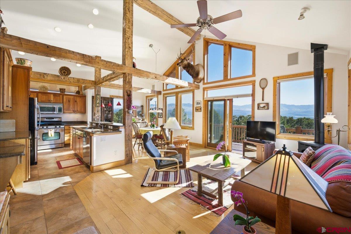 Nestled at the end of a quiet cul-de-sac on 4.8 acres with beautiful views of both the Cimarrons and San Juans, this home is a delight! As you enter the main door you immediately feel the openness of the floorplan and the wonderful natural light as the great room, dining room and kitchen are wrapped in windows. Visiting friends and family will enjoy the fact that everyone can be together is this amazing space, plus go out on the deck and enjoy the views. The wood beams are white oak and came from an old barn in Ohio, the floors are red oak and 18" tile, the interior doors are knotty pine, the kitchen appliances and sink are stainless, the cabinets are rustic cherry,  the counters granite, and a sound system adds the perfect touch! All combine to make this area unbelievably warm and inviting. This main floor is also home to the carpeted master bedroom, tiled bath and another carpeted bedroom that can easily double as an office. The laundry and half bath for guests round out this floor. Overnight guests and family have their own bedroom and bath downstairs. A four-person spa on the east side is a welcome feature especially after a day of skiing or hiking! The heated garage is oversized with a utility sink, epoxy floor, hot and cold water for washing the car, a new door opener, and plenty of room for the “tinkerer”. The exterior was thoughtfully done with HardiePlank and stucco, Trex decking, and a metal roof. There is a separate storage building for “toys” or other equipment.  Built to require minimal upkeep, leaving plenty of time to enjoy all that Ouray County and the surrounding area has to offer, this is an exceptionally warm, comfortable home is a quiet, private location.