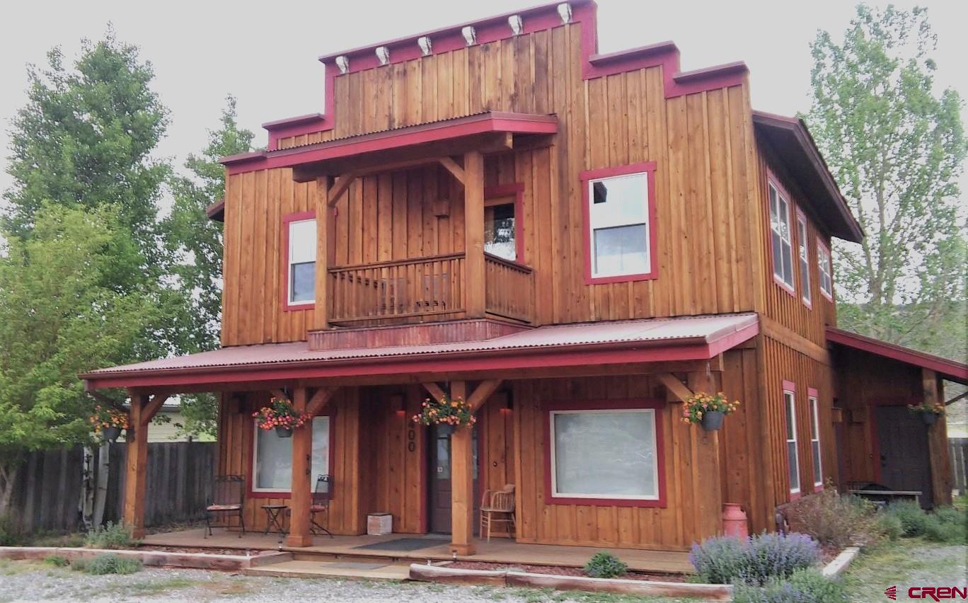 Unique Multi-Use Property in Ridgway – Prime Commercial & Residential Opportunity in recently constructed building! Seize this rare opportunity to own one of Ridgway’s most versatile and intelligently designed properties! This exceptional Residential/Commercial/Multi-Use building is a testament to thoughtful planning, blending contemporary residential features with Western Victorian charm. Whether you're an entrepreneur, investor, or someone seeking a live/work space in the Ridgway, Ouray and Telluride area, this property offers unparalleled flexibility.  Maximize Income Potential with Smart Zoning Strategically built within Ridgway’s General Commercial zoning, this property is currently configured as two distinct residential and commercial units:  Lower Level: A commercial space that allows for short-term rentals (up to 29 days) or a variety of business uses, including retail, office space, professional services, breweries, art or antique galleries,  or even light manufacturing. Upper Level: A beautifully finished residential unit, ideal for long-term living or short-term vacation rentals (VRBO/Airbnb) under a Ridgway short-term rental license. With this dual-purpose setup, you can generate rental income from both floors or utilize one as a residence while running a business from the other—a rare find in Ridgway!  Designed for Efficiency & Timeless Appeal This custom-built flexible property blends perfectly into the vibrant Ridgway community while offering: High-quality materials & craftsmanship, covered parking & dual entrances for convenience, expansive porches & decks designed for privacy and stunning views, landscaped grounds with mature trees & perennials, state-of-the-art heat pump system for efficient heating, cooling, and air filtration. With an impressive building footprint and room to expand, this property presents a prime opportunity for growth. Add another rental unit, increase commercial capacity, or reconfigure the space to match your unique vision—all while maintaining ample off-street parking and accessibility.  Located at the very eastern edge of Ridgway, just a quick walk to the center  of Town, and just minutes from Ouray’s hot springs and Telluride’s world-class skiing, this property places you in one of Colorado’s most sought-after areas for both tourism and year-round living.  Whether you dream of running a business, investing in Ridgway’s thriving market, or creating the ultimate live/work space, this multi-use property offers unmatched potential. Schedule a showing today and start building your future in Ridgway, Telluride, and Ouray!