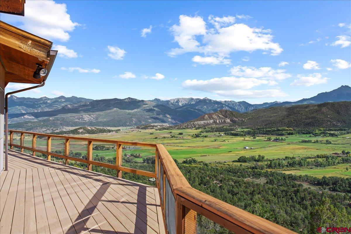 When you imagine your dream home in Colorado, it’s all about the views—the kind that stop you in your tracks every single day. This is where those dreams become reality.  From your living room windows, take in the iconic silhouette of Mt. Sneffels, perfectly framed like a masterpiece. Sweep your gaze across the vast San Juan and Cimarron mountain ranges, where evenings can deliver a show—Chimney Peak and Courthouse Mountain glowing in shifting hues of gold, orange, pink, and lavender during breathtaking alpenglow.  Set on 39 private acres in Pleasant Valley, this 3-bedroom, 2-bath home offers unmatched serenity with no HOA and no covenants. There is a 2 car attached garage, as well as a large one car detacted garage/workshop.  Paved access ensures year-round convenience, while the expansive setting provides the perfect opportunity to maximize solar energy potential. A solar hot water system is already in place, supporting a sustainable mountain lifestyle.  Step outside your door and into adventure—hike, bike, run, or simply explore the surrounding beauty right from your own land.  Despite its privacy, this home is ideally located just 10 minutes to Ridgway, 40 minutes to Telluride,  30 minutes  to Montrose Regional Airport.  Whether you're seeking a full-time residence, a retreat, or a basecamp for mountain living, this property delivers the rare combination of big views, privacy, and accessibility. This is more than a home—it’s your front-row seat to the San Juans.