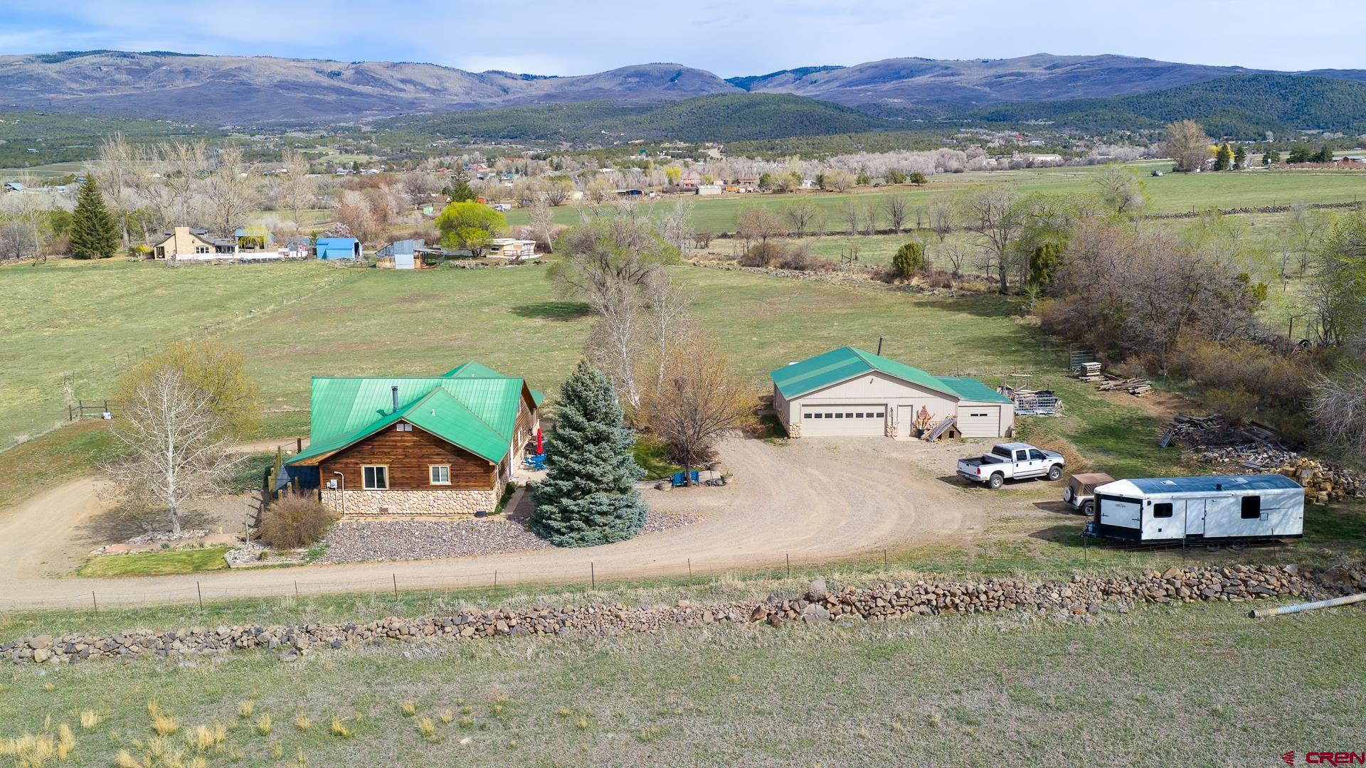 3000 sq. ft. Custom home near Cedaredge on 1 acre being offered for the very first time! Excellent location and tremendous Grand Mesa views with good elbow room gives a remote feeling of solitude but is within minutes to town. Vaulted tongue and groove ceilings with a window package that lets in an abundance of natural light brighten the home. Large kitchen with custom wood cabinetry and complimentary granite countertops and kitchen island provide a space to gather and prepare. Split floorplan with ample guest bedrooms and full bath over to the main bedroom with a nice 3/4 bath with a tiled walk-in shower and granite vanity top. Loft area makes for a great office space. The Walk-out basement serves as additional living space with a full kitchen, bath, bedroom, and laundry. Gas free standing stove heats the upstairs with a wood stove handling the basement. There is a also a gas boiler that provides radiant heat in the home. Metal roof. The detached 2 car garage has ample parking room and space for a workshop. Plenty of room around the property to park cars or trailers and maneuver with a big circular driveway. No HOA or covenants. Property is gated and fully fenced. Nice mature trees and lawn in back provide good shade and space. Come grab your slice of paradise!