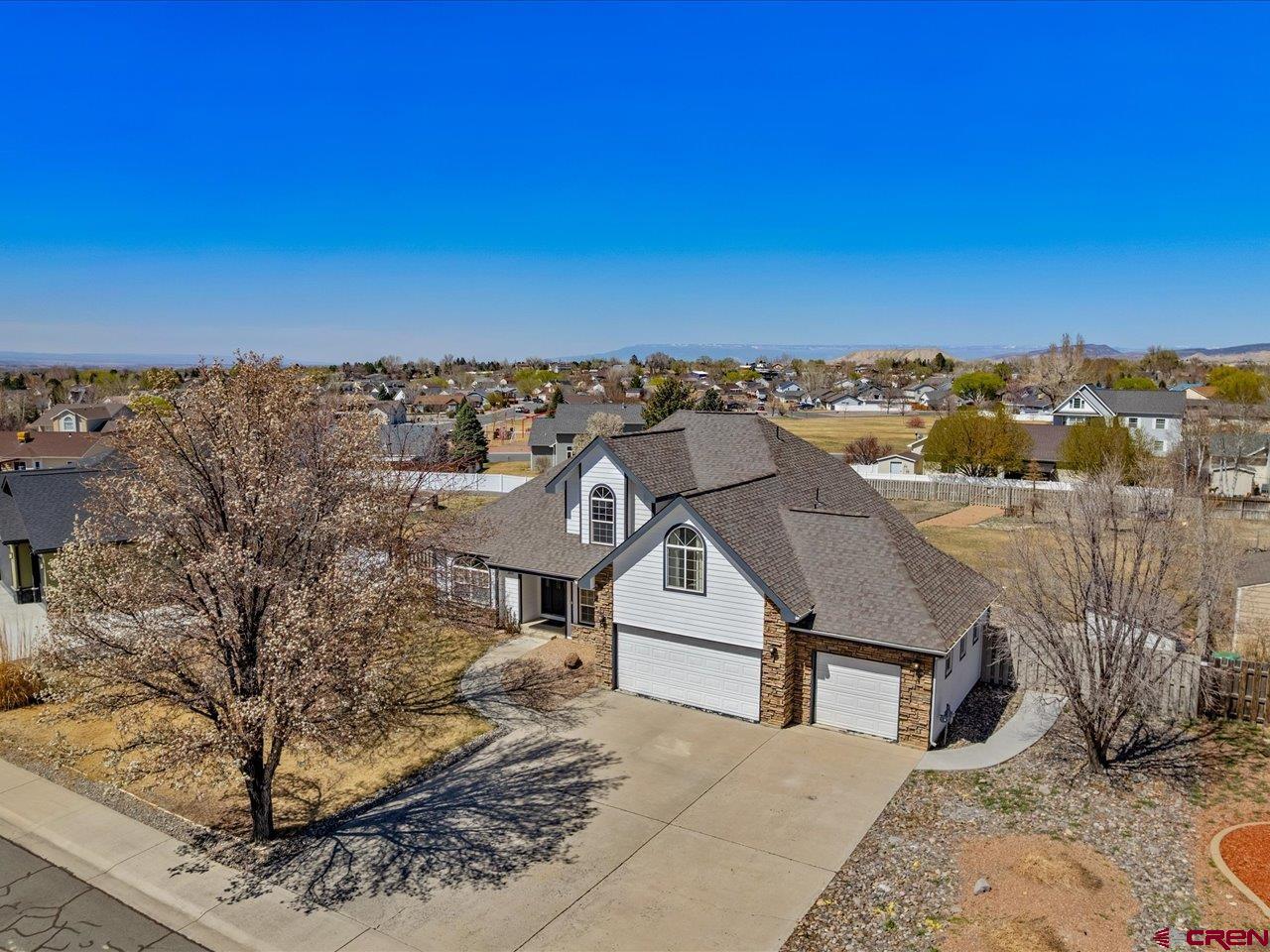 Timeless Elegance in Fox Park. Welcome to this beautifully appointed four-bedroom, three-bath residence, gracefully situated on over half an acre in the highly sought-after Fox Park community. New mini split installed on Wifi with app control built in for temperature control (2026), new roof installed (2025), and a brand-new concrete backyard patio and walkway (2023). Thoughtfully designed and meticulously maintained, this home offers both sophistication and comfort in equal measure. Step inside to discover expansive living spaces, including a gracious living room with a cozy gas fireplace, a spacious family room, and a formal dining room perfect for elegant gatherings. The open-concept kitchen is as functional as it is inviting, complemented by generous pantry storage and seamless flow to the main living areas. Retreat to the serene primary suite, where a luxurious en-suite bath awaits—complete with dual vanities, a soaking tub, a walk-in closet, and in-floor heating. Three additional bedrooms, a dedicated office, and a well-placed laundry room ensure space and convenience for every lifestyle. Outside, take in the sweeping mountain views from the new concrete private back patio and walkway, surrounded by a fully landscaped yard with mature trees, a sprinkler system, and an adjacent community greenbelt that enhances privacy. Additional highlights include new paint, garden area, storage shed, Smart Controlled heating and cooling with app, and a spacious three-car garage. Fox Park residents enjoy access to exclusive neighborhood amenities, including a secured RV and boat parking area, beautifully maintained common spaces, and a nearby playground. Ideally located near top-rated schools, shopping, recreation, and the natural beauty of Montrose, this exceptional home offers a rare blend of luxury, space, and tranquility. Call Your Favorite Agent for a Tour Today!