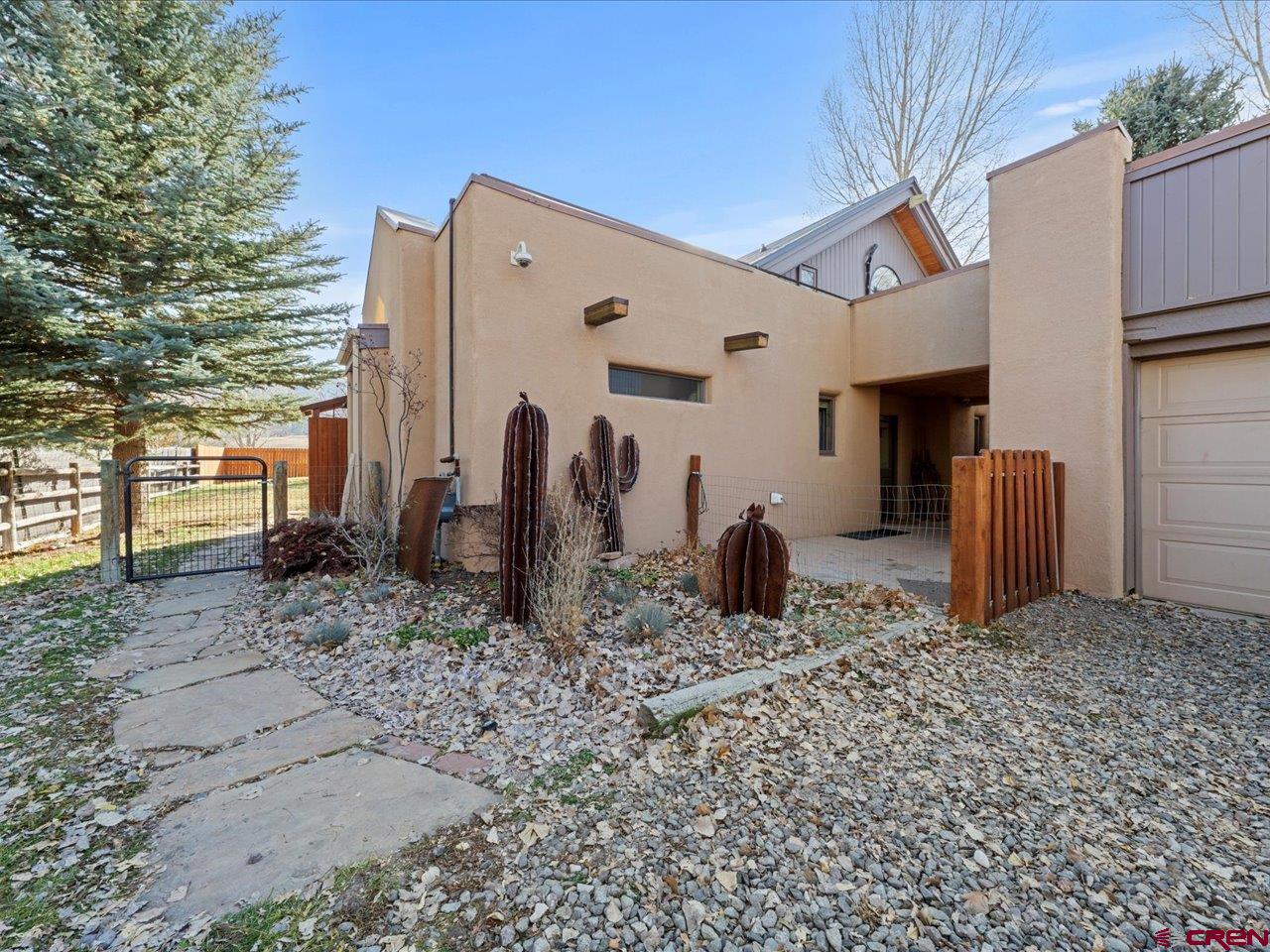 NEVER BEFORE. NEVER AGAIN. A TRUE ONE-OF-ONE OPPORTUNITY IN SOLAR RANCH. This is not just a home — it’s a strategic opportunity that has never existed in the history of Solar Ranch, and quite possibly will never come again.  Included in the purchase is not only the home, but also the lot directly in front of it — creating a combined parcel of approximately half an acre and, most importantly, permanent control of your view corridor. That means no one will ever build in front of you — your sweeping San Juan and Cimarron views are yours to keep.    The existing residence is a classic Southwestern-style home offering:    3 bedrooms / 2 baths on the main level (1,418 sq ft) Upstairs: 1 bedroom + office/non-conforming bedroom + bath (581 sq ft) Separate or interior access — ideal for rental income, guest quarters, or multigenerational living In-floor heat, mini-split in primary, and a mix of engineered wood, tile, and carpet