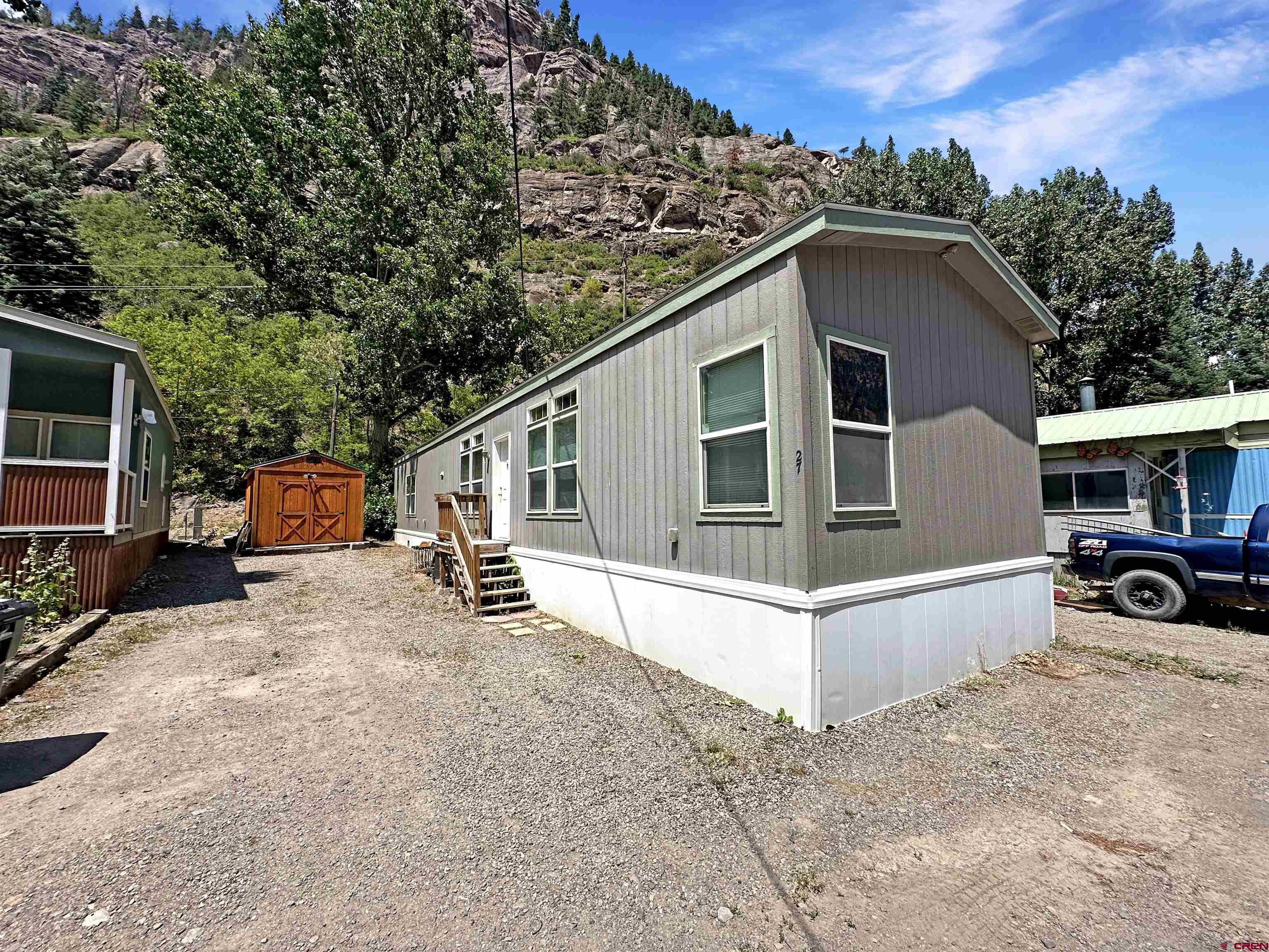 Comfortable Affordable Living in the Heart of the City of Ouray. Here’s an opportunity to own your own place in one of Colorado’s most iconic mountain towns. This 2016-built, move-in ready manufactured home offers 1,130 square feet of well-designed living space with 3 bedrooms and 2 full baths, featuring a bright, open layout that feels both comfortable and practical. It also has a large storage shed for your summer and winter recreation gear. Located in the well-kept 4J RV Park community, this home puts you right where you want to be. You’re within walking distance to the famous Ouray Hot Springs Pool, downtown shops, local restaurants, and everything that makes Ouray such a special place to live or visit. Whether you’re looking for a full-time residence, a low-maintenance getaway, or a place to land after a day of work or adventure, this property offers flexibility and ease. Spend your mornings with coffee and mountain views, your afternoons exploring trails or the Million Dollar Highway, and your evenings soaking in the hot springs or enjoying town. Opportunities at this price point in Ouray are hard to come by. This home offers a simple, comfortable way to enjoy mountain living without overcomplicating things.